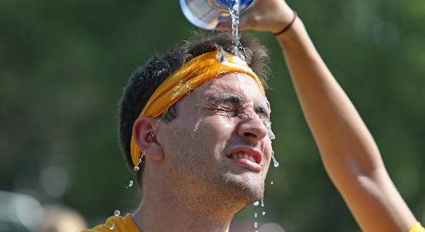 University of Minnesota senior Jake Barnett celebrated the end of his shift of moving freshmen into their dorms with water over his head, Monday, Augu