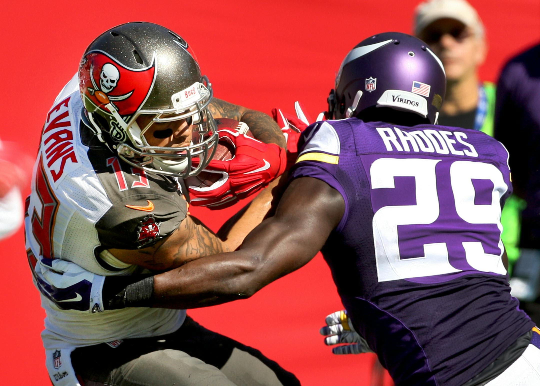 Tampa Bay Buccaneers wide receiver Mike Evans (13) is tackled by Minnesota Vikings cornerback Xavier Rhodes (29) during the second half of an NFL football game on Sunday, Oct. 26, 2014, in Tampa, Fla. The Vikings won 19-13. (AP Photo/Reinhold Matay)
