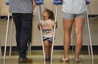 Harper Stone, 2, looked to her father and mother, Mandela and Tommy, as they voted Tuesday night at Edison High School in northeast Minneapolis. "It's