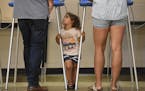 Harper Stone, 2, looked to her father and mother, Mandela and Tommy, as they voted Tuesday night at Edison High School in northeast Minneapolis. "It's