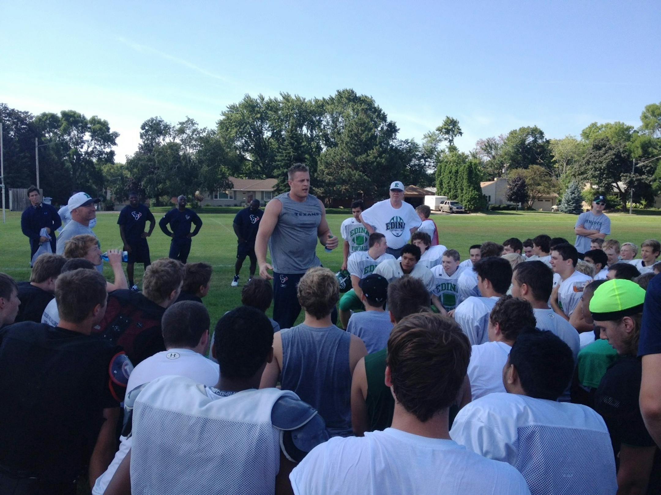 Houston Texans defensive end J.J. Watt talks to Edina football players Friday morning, August 9, 2013, at Kuhlman Field in Edina. The Texans are in town to play the Vikings in an NFL preseason game.