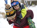 Barbra Skubitz from Arden Hills carried her neighbor Alex on her back during the Rock the Cradle Pop Up Ski Party at Afton Alps.