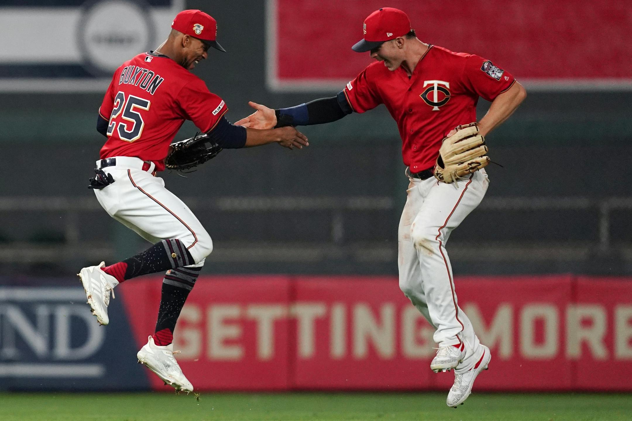 Minnesota Twins center fielder Byron Buxton (25) celebrated with Minnesota Twins right fielder Max Kepler (26) in the outfield after the win.