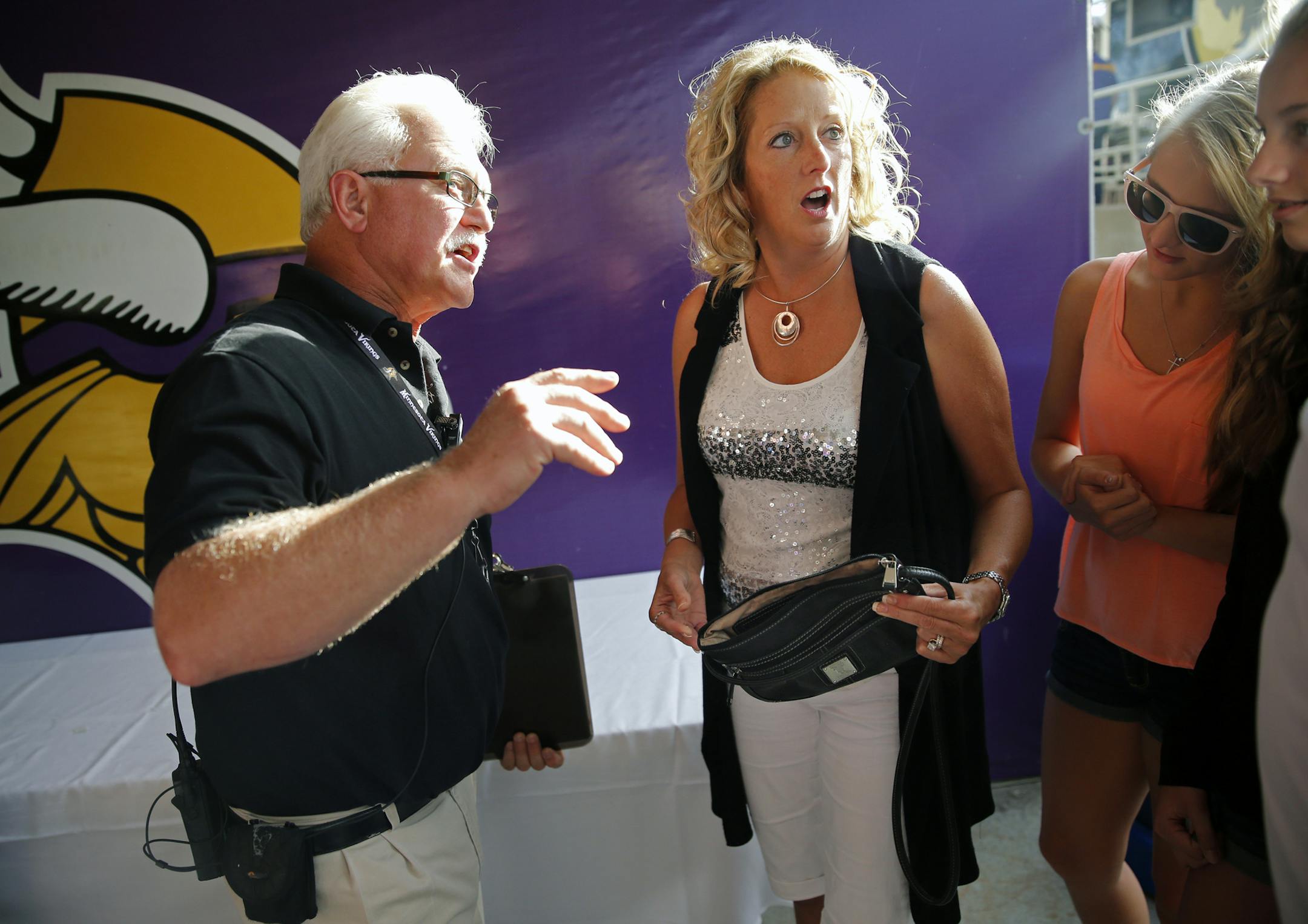 At the Metrodome, the NFL has instituted that non-clear bags larger than 4.5" by 6.5" cannot be brought into the stadium. Left to right, security supervisor Steve Smith told a very frustrated Jody Volk of Mankato that her purse way too big too bring inside. "Who is going to carry a clear plastic bag with feminine products?," said Volk who was with daughters Lexi and Alix.] tsong-taataarii@startribune.com