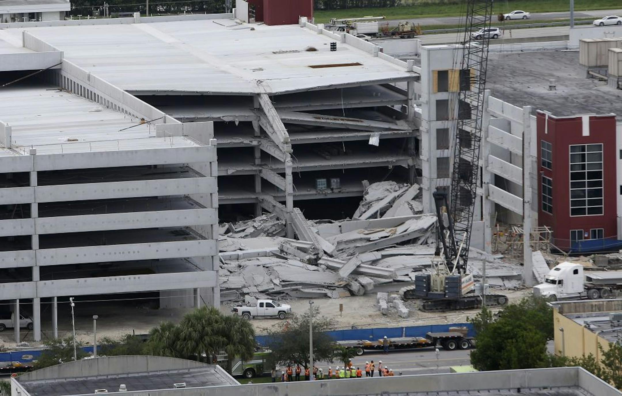 A five-story parking garage is shown after it collapsed at Miami-Dade College, Wednesday, Oct. 10, 2012 in Doral, Fla., killing one worker and trapping two others in the rubble, officials said. Several other workers were hurt, including one rescued from the debris.