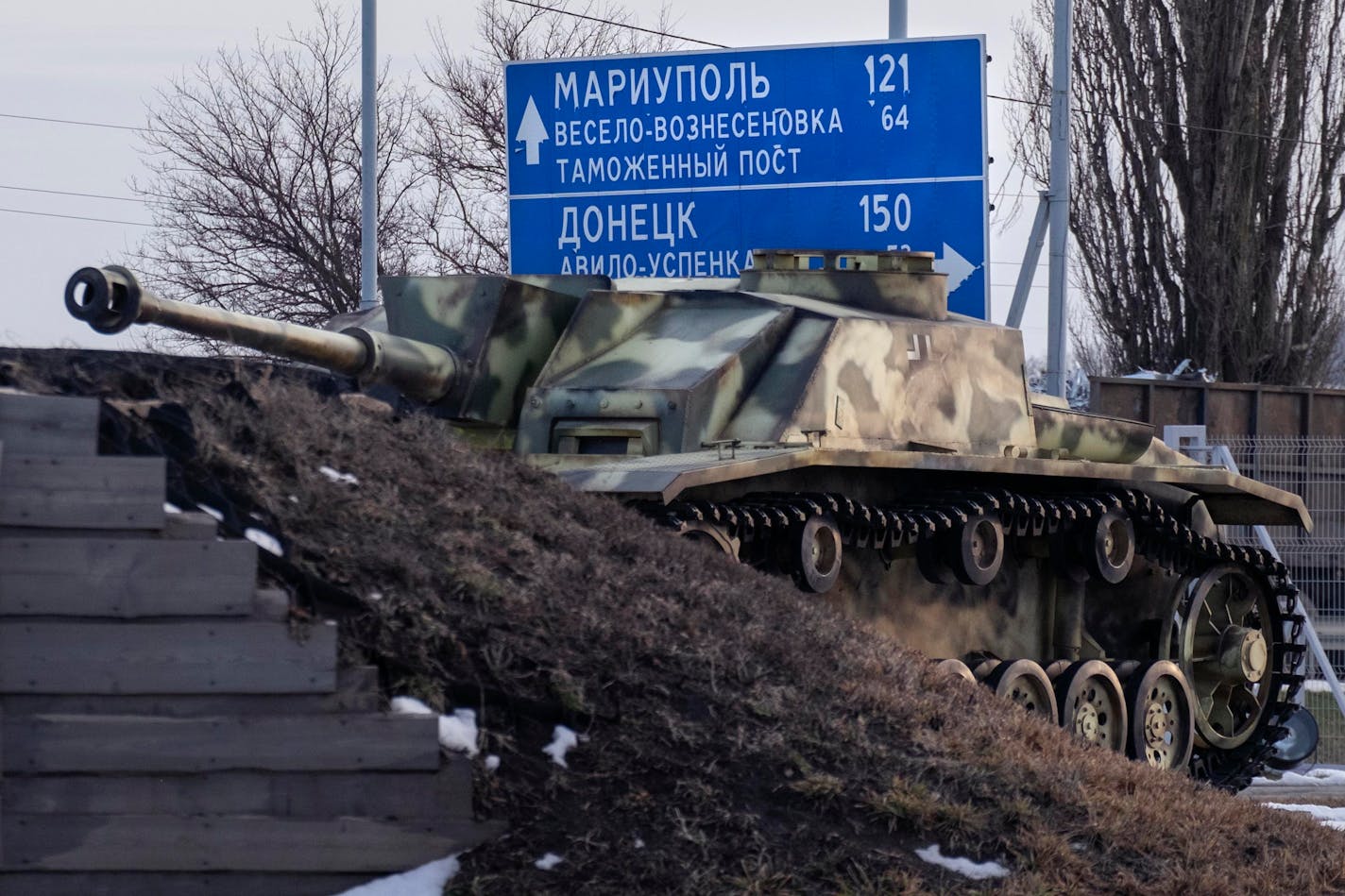 An old German tank stands by a road sign in Rostov-on-Don that points the way to Donetsk and Mariupol in Ukraine. MUST CREDIT: Photo for The Washington Post by Arthur Bondar.