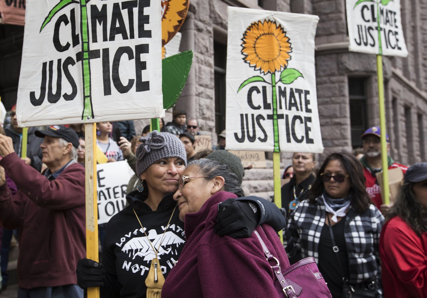 Williamette Hardy, right, of the Red Lake Reservation gets a hug from Gio Cerise of White Earth during a rally in Minneapolis. The ladies met at the Dakota Access Pipeline protest camp. ] (Leila Navidi/Star Tribune) leila.navidi@startribune.com BACKGROUND INFORMATION: People rally against deputies from the Hennepin County Sheriff's Office being sent to the pipeline protests in North Dakota outside of City Hall in Minneapolis on Tuesday, October 25, 2016. After the State of North Dakota requested