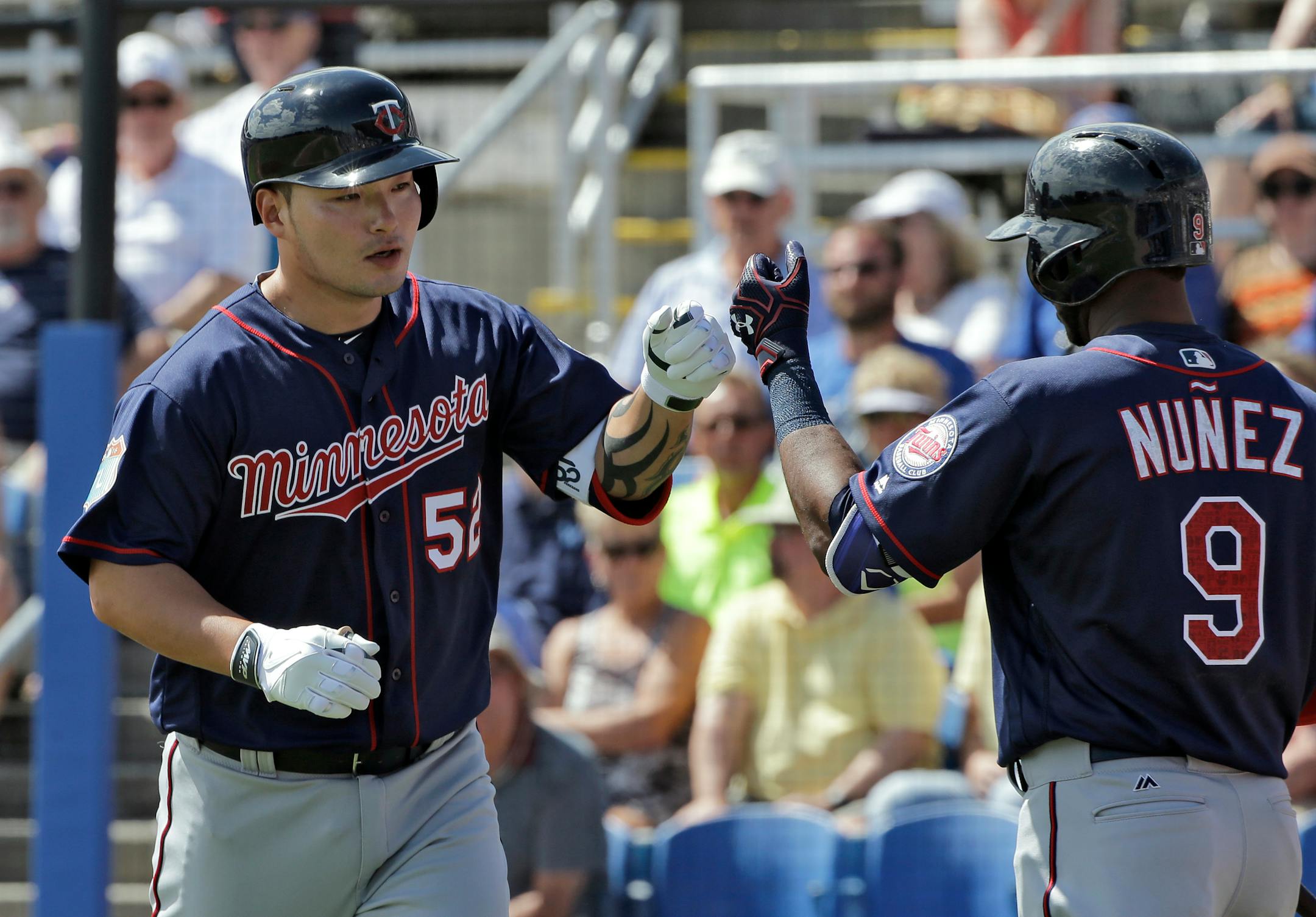 Minnesota Twins' Byung Ho Park, left, of South Korea, celebrates with on-deck batter Eduardo Nunez after his home run off Toronto Blue Jays starting pitcher Gavin Floyd during the second inning of a spring training baseball game Tuesday, March 8, 2016, in Dunedin, Fla. (AP Photo/Chris O'Meara)