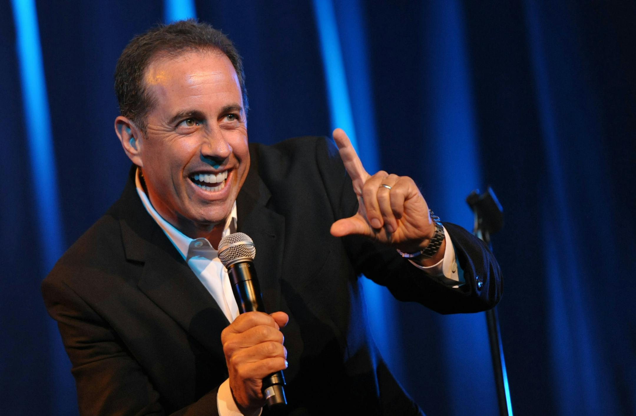 FILE - This June 30, 2012 file photo released by the David Lynch Foundation shows comedian Jerry Seinfeld performing onstage at the David Lynch Foundation: A Night of Comedy honoring George Shapiro in Beverly Hills, Calif.