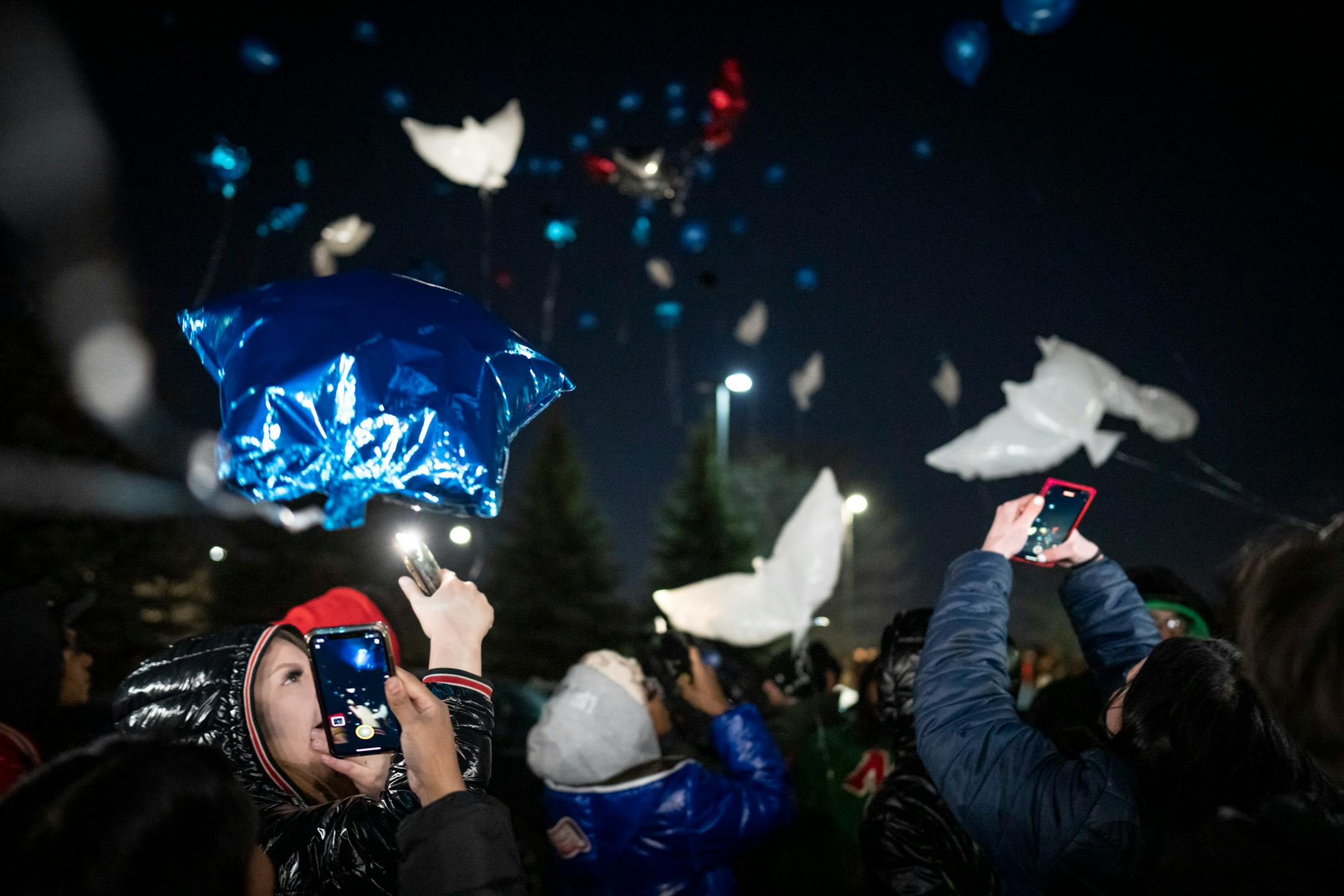 Friends, family and teachers of Jahmari Rice release balloons, including dove shaped balloons during a vigil for the one year anniversary of the death of 15-year-old Jahmari Rice.