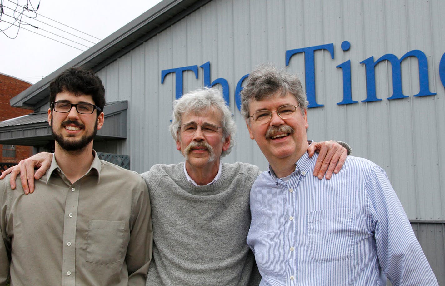 Art Cullen, center, editor and co-owner of the Storm Lake Times, posed for a photo with his son, Tom, left, and brother, John, outside the paper in Storm Lake, Iowa, after Art won the Pulitzer Prize for editorial writing. Cullen's writing took on powerful agricultural groups for allowing nitrogen runoff to pollute lakes and streams and wrote that the state "has the dirtiest surface water in America."