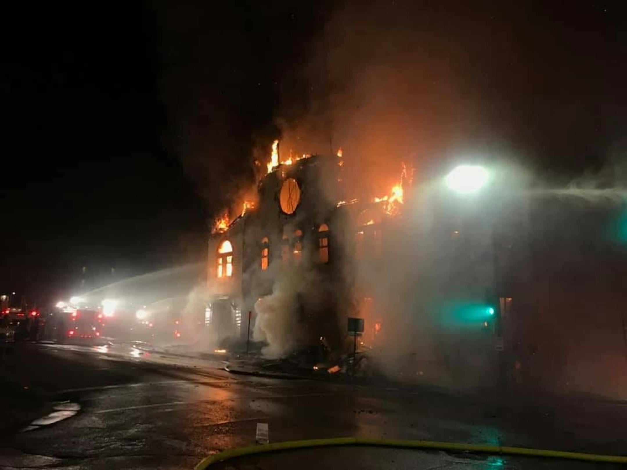 An overnight fire engulfed and destroyed a synagogue in downtown Duluth and continued to burn many hours later Monday morning. Photo courtesy KBJR-TV.