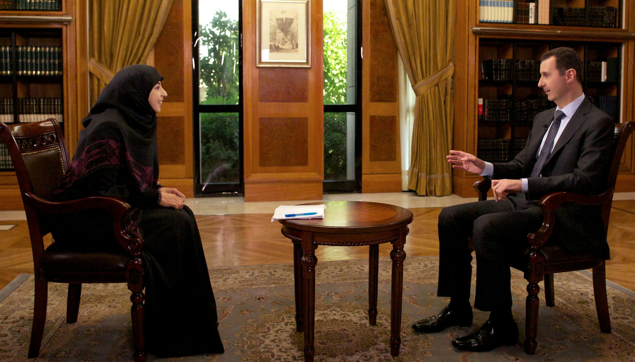 In this photo released by the Syrian official news agency SANA, Syrian President Bashar al-Assad, right, speaks during an interview with Al-Manar TV, owned by the militant Hezbollah group, in Damascus, Syria, Thursday, May 30, 2013.(AP Photo/SANA)
