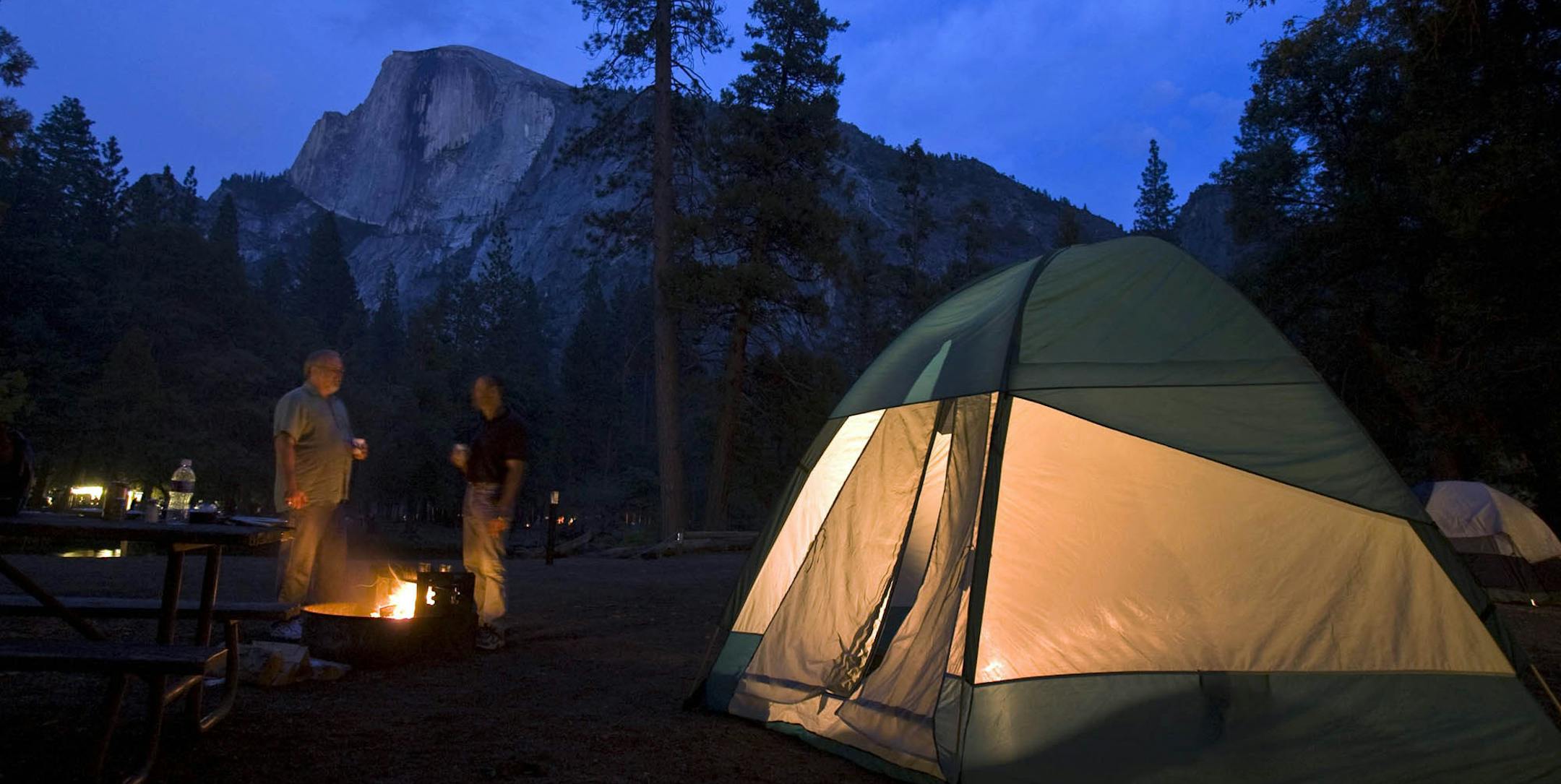 Keith Roberts and Terry Garner of Houston had a view of Half Dome at their Yosemite National Park camp on May 29, 2009. In a rugged economy, more Americans are heading to national parks this year for a vacation in the great outdoors. But there is still room for a few more tents out there. (Peter DaSilva/The New York Times)