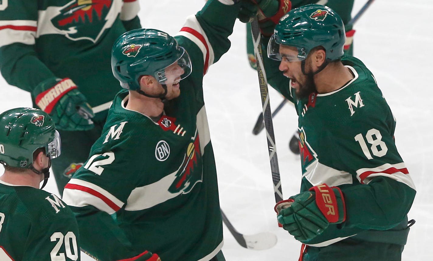 Minnesota Wild's Eric Staal, center, congratulates Jordan Greenway, right, on Greenway's goal off Columbus Blue Jackets' goalie Sergei Bobrovsky, of Russia, during the first period of an NHL hockey game Saturday, Jan. 19, 2019, in St. Paul, Minn. (AP Photo/Jim Mone)