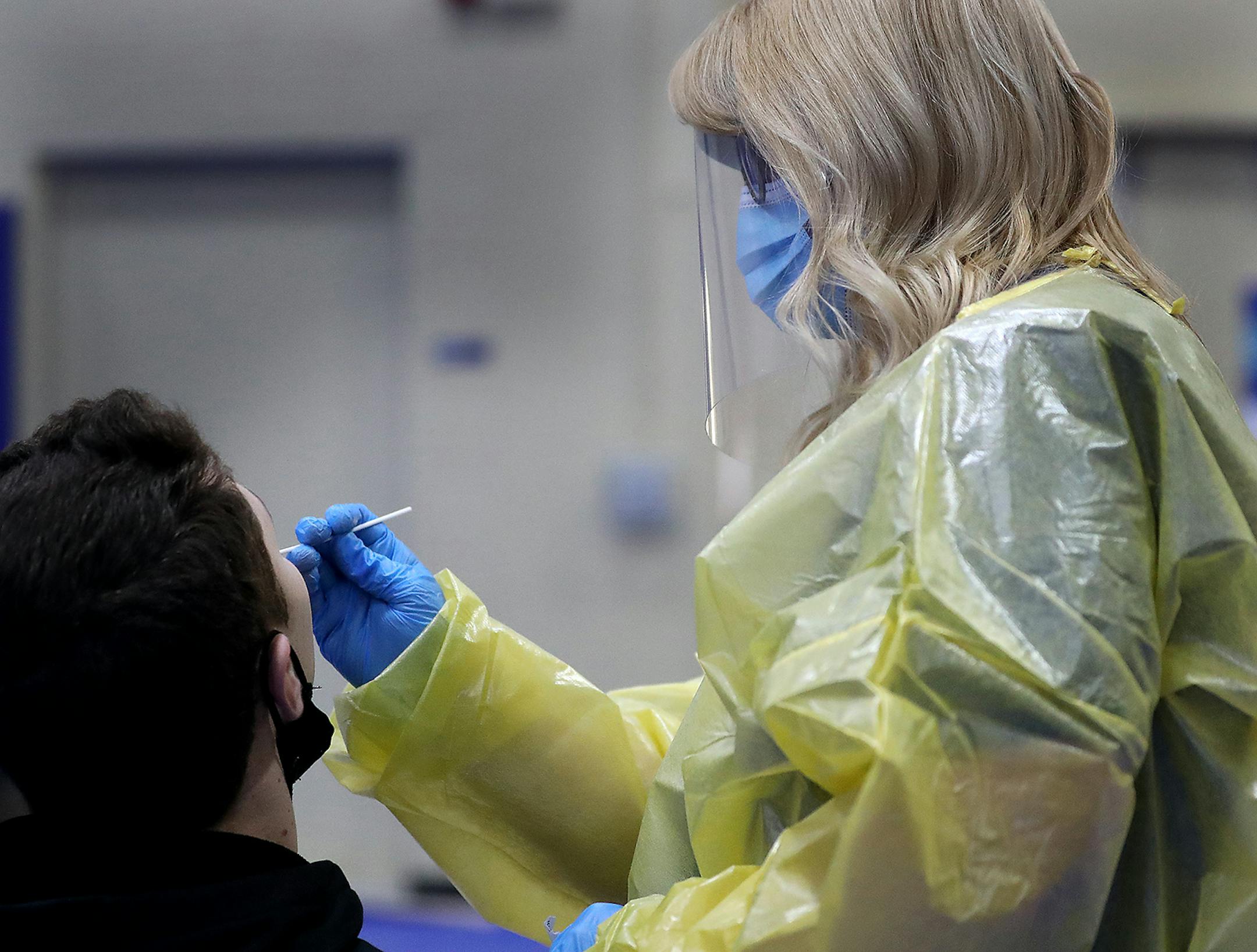 Jennifer Schmidt, a traveling RN, conducts a nasal antigen test on a student at the University of Wisconsin Eau Claire Monday in Eau Claire, WI.
