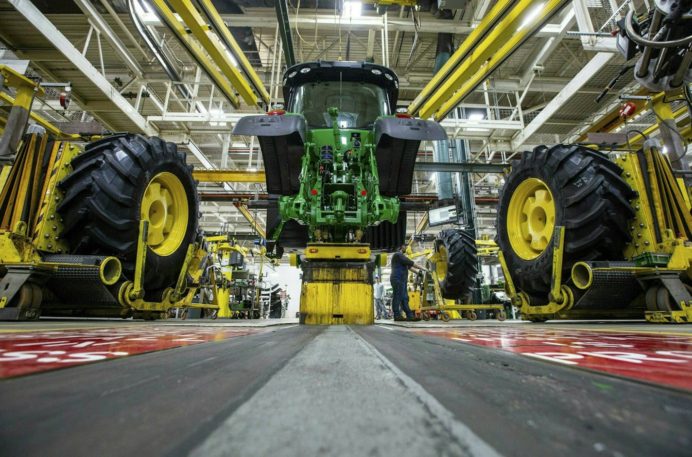 The Farm Bureau is turning up the pressure on equipment manufacturers to give farmers more leeway to work on tractors and other equipment that has become highly technical. File photo of John Deere's Waterloo, Iowa assembly plant.