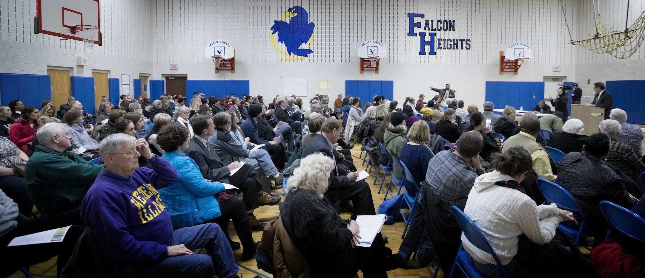 Attendees listened to a citizen speak during a Department of Justice listening session at Falcon Heights Elementary School on Monday night.