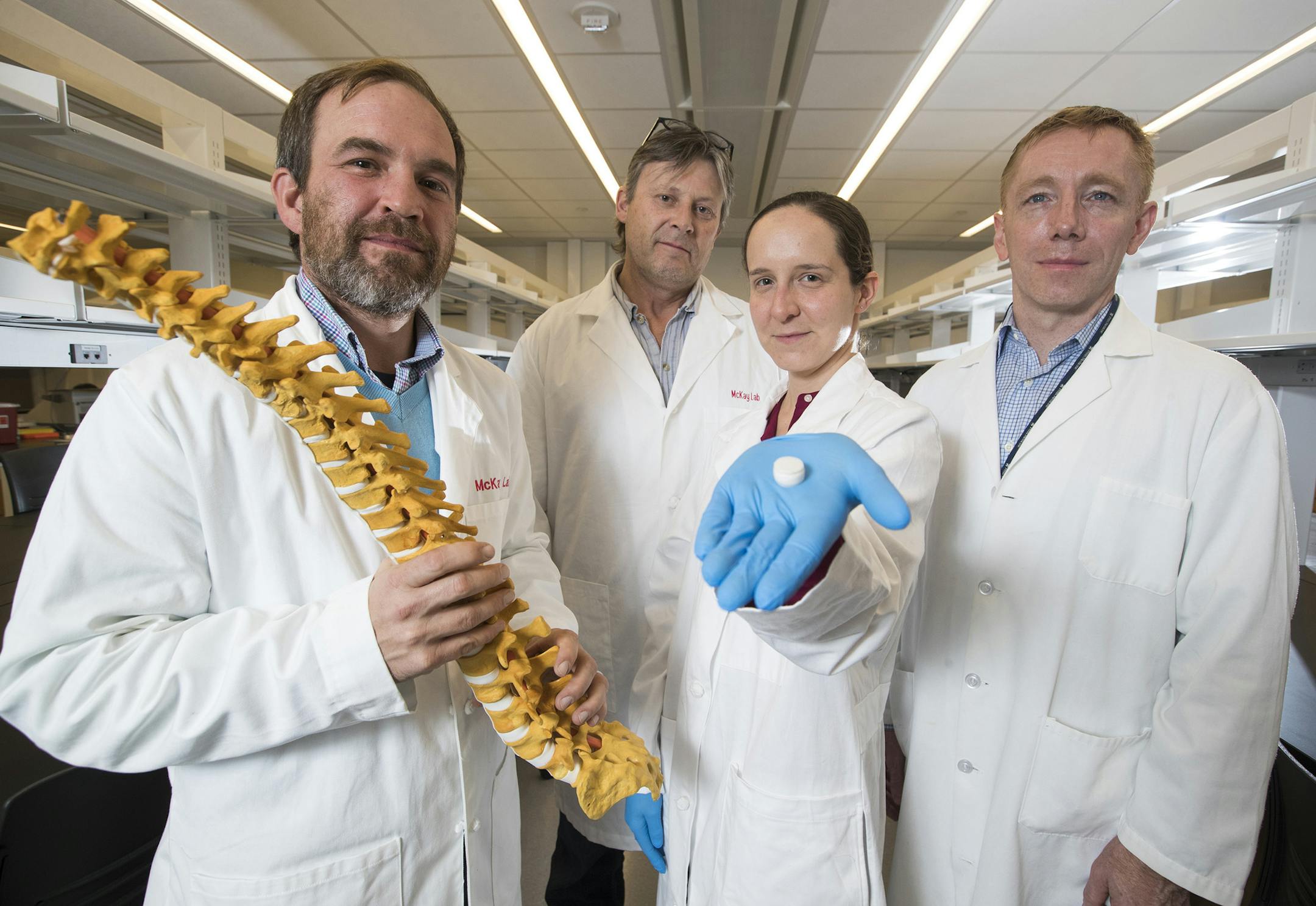 Penn scientists are making synthetic discs like the one held by Sarah Gullbrand, center, to replace herniated discs in the spine. She and colleagues Rob Mauck (left), Tom Schaer, and Harvey Smith have tested the discs in goats and rats. (Charles Fox/Philadelphia Inquirer/TNS)