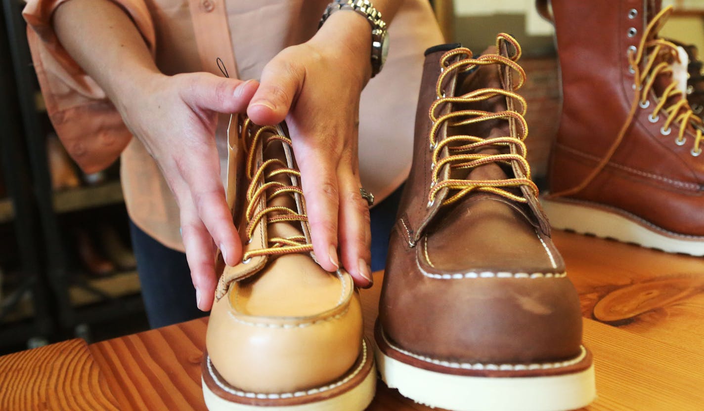 Allison Gettings, Red Wing Shoe director of product creation, Legacy talks about the difference in the women's and men's line of a similar boot at the Red Wing Shoes headquarters Thursday, July 21, 2016, in Red Wing, MN. The women's boot on the left is made using leather from heifers while the men's on the right is used from leather made from steer.](DAVID JOLES/STARTRIBUNE)djoles@startribune Red Wing Shoes, which is famous for its lumberjack-chic work boots, is launching its first line of women