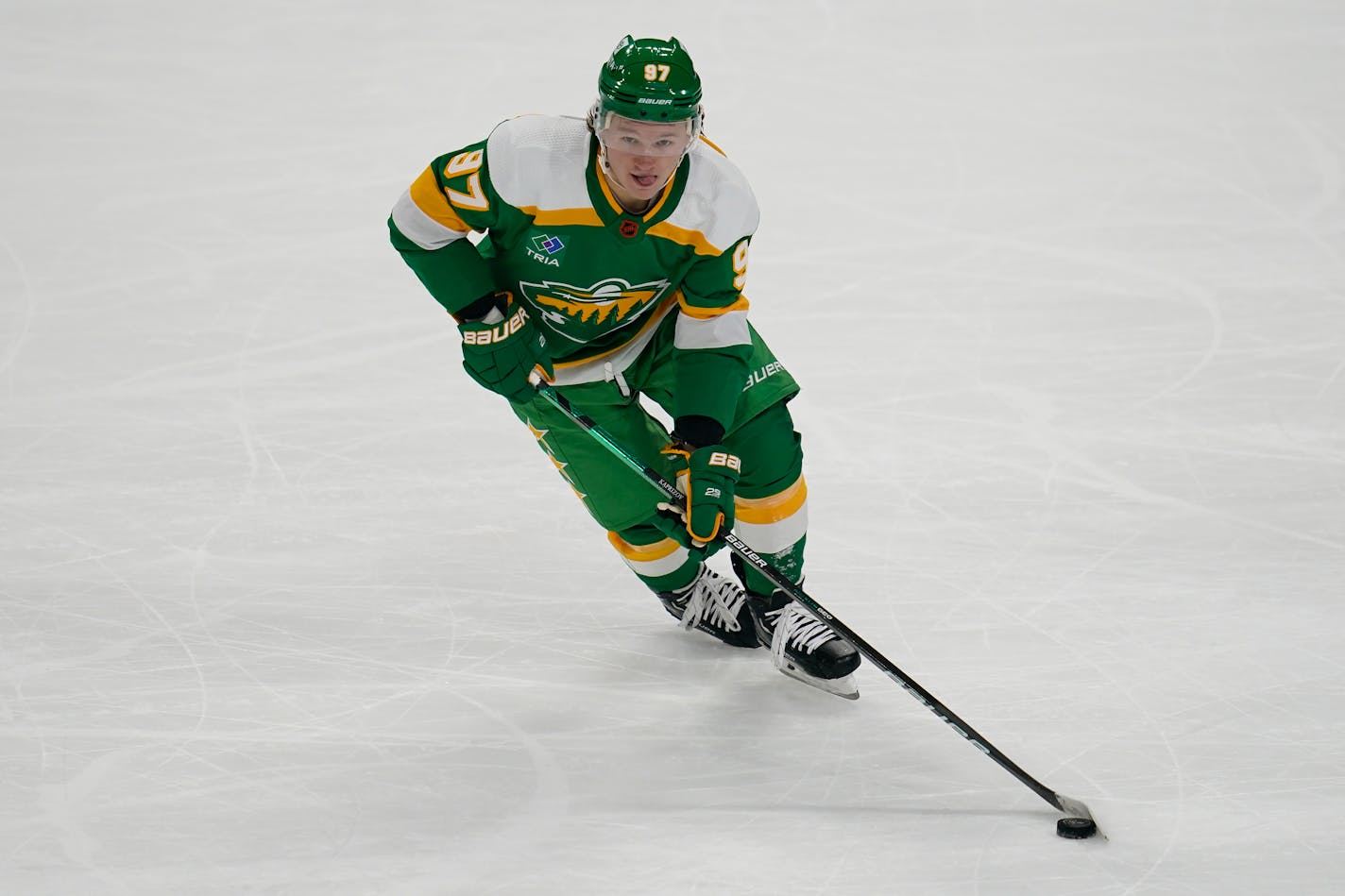 Minnesota Wild left wing Kirill Kaprizov (97) skates with the puck during the first period of an NHL hockey game against the Chicago Blackhawks, Friday, Dec. 16, 2022, in St. Paul, Minn. (AP Photo/Abbie Parr)