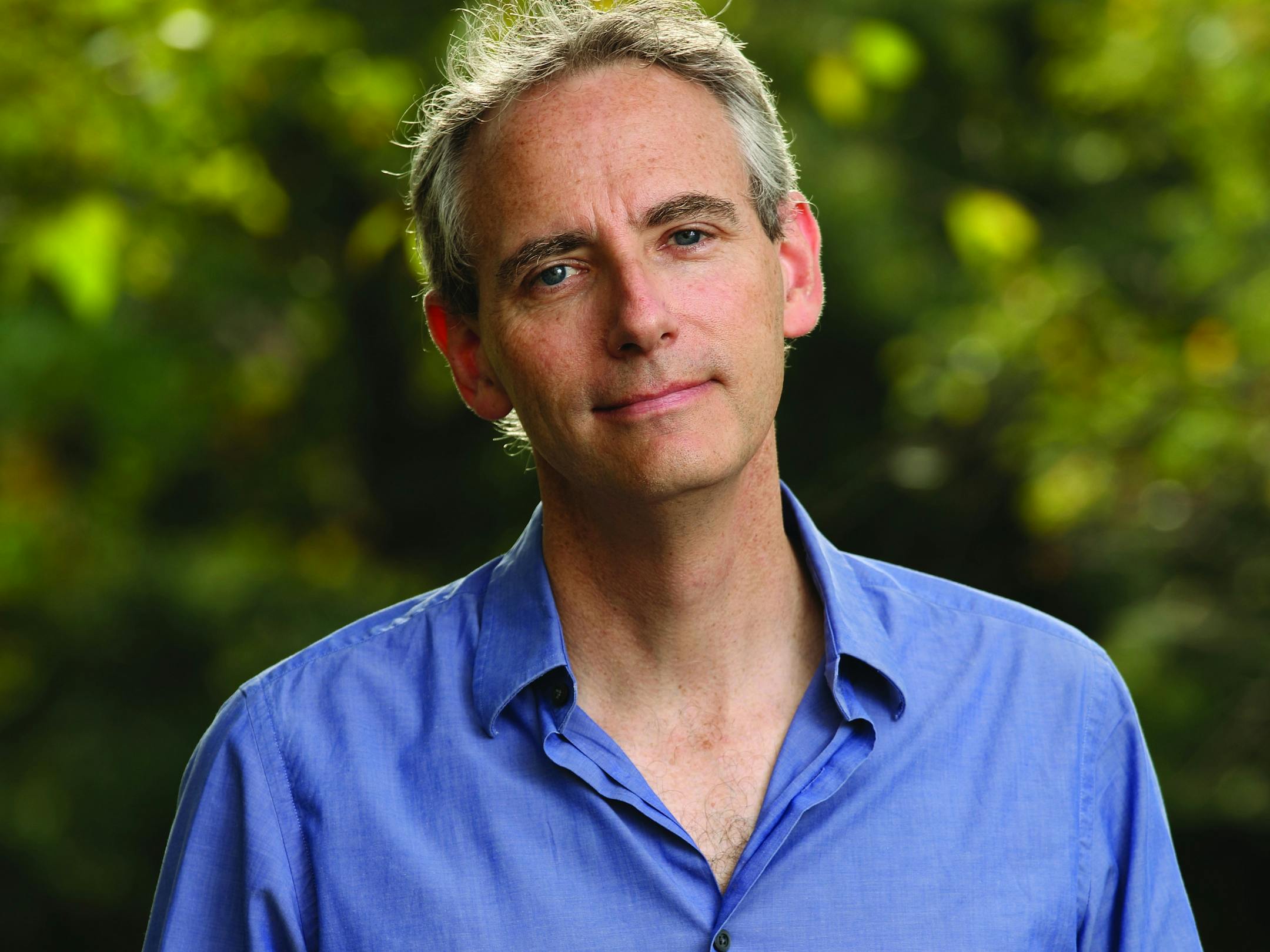 photo of author Bruce Holsinger, in front of some greenery