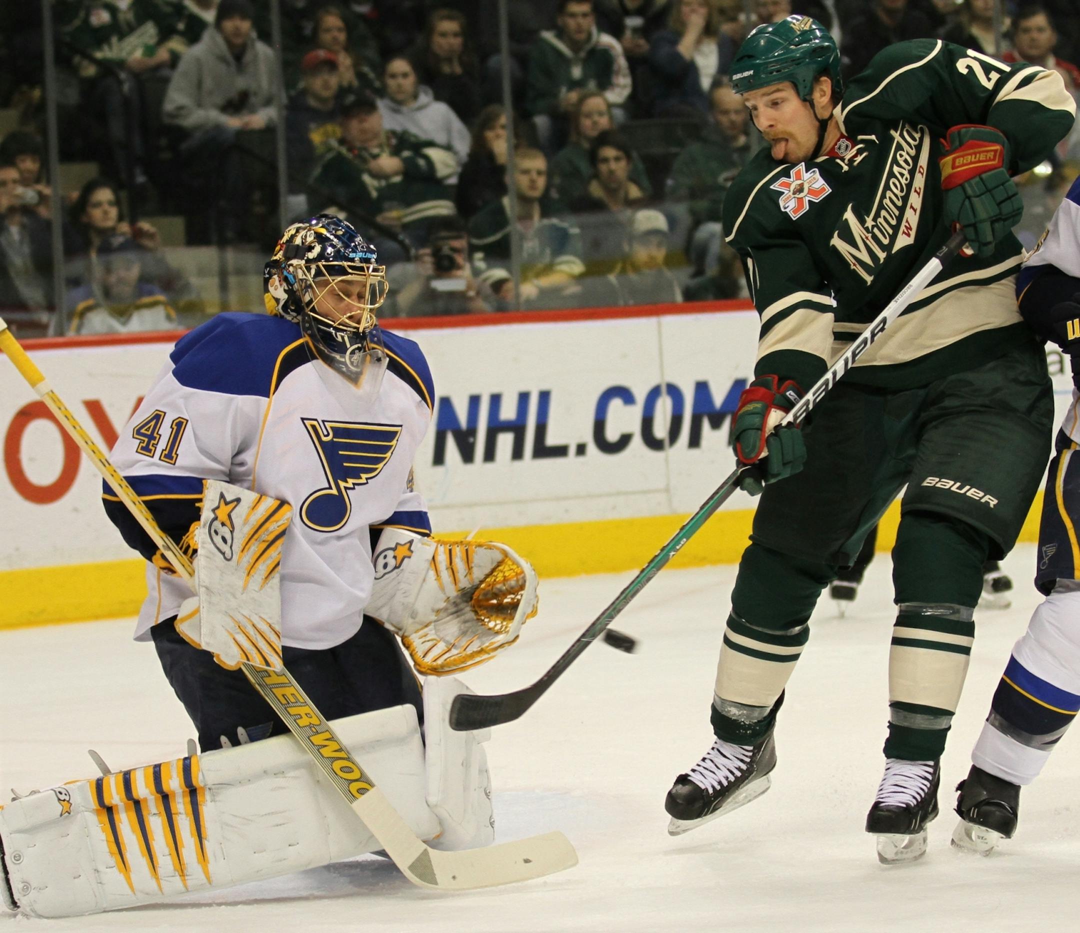 Wild forward Kyle Brodziak (right)