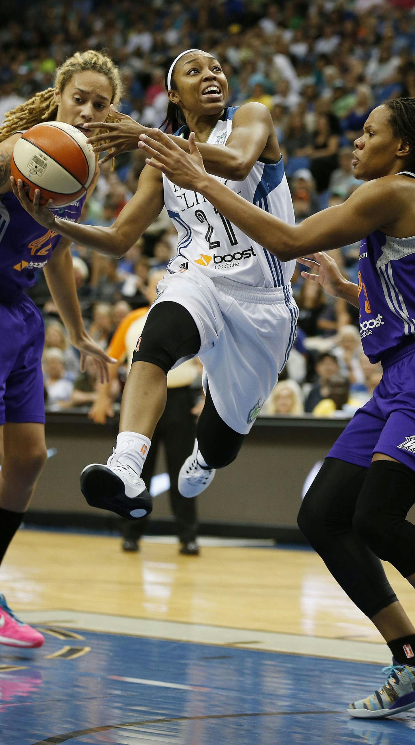 Minnesota Lynx guard Renee Montgomery (21) pushes up to the basket against Phoenix Mercury forward Monique Curry, right, during the first half of a WNBA basketball game, Sunday, Aug. 30, 2015, in Minneapolis. (AP Photo/Stacy Bengs)