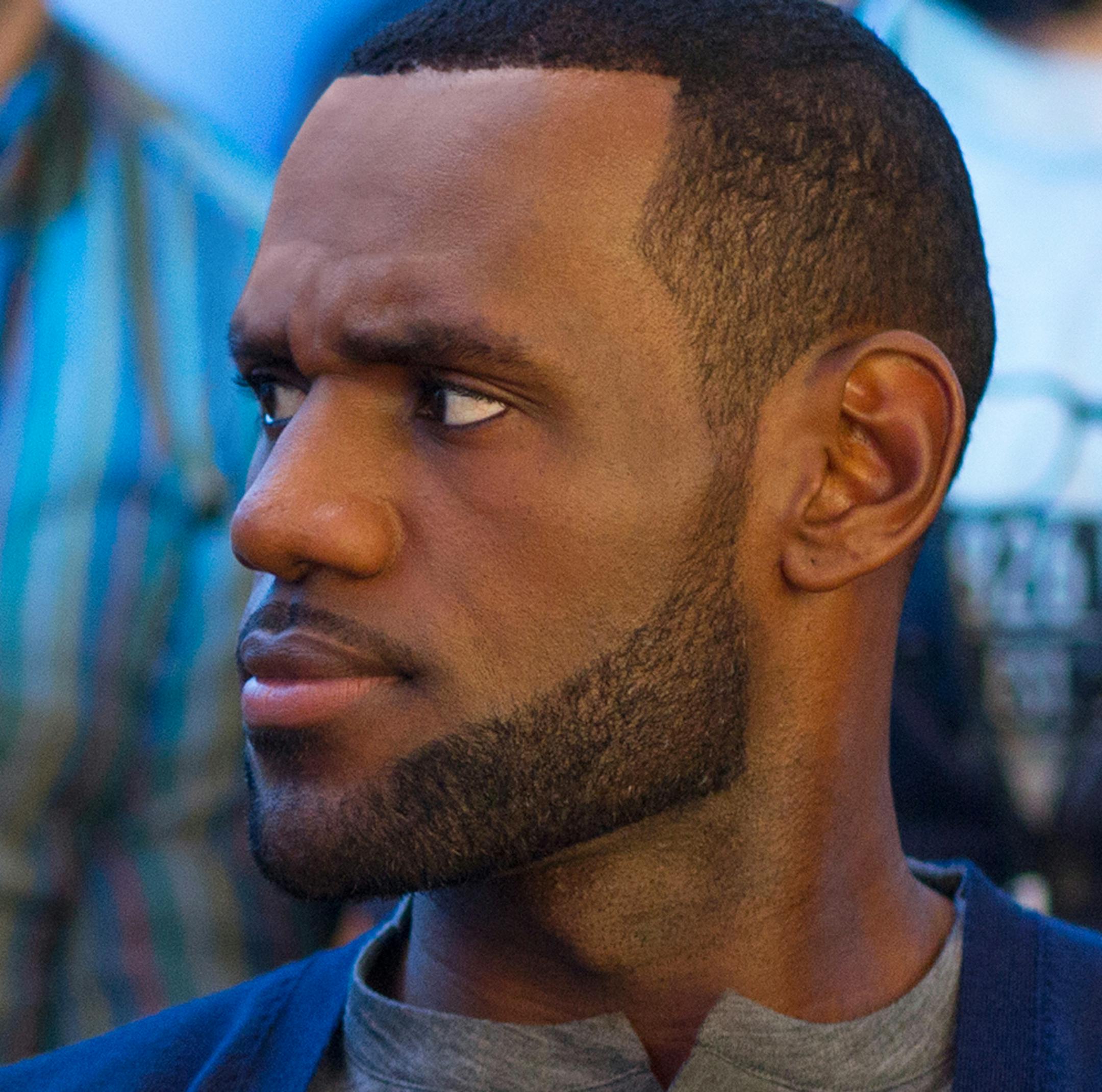 This image released by Universal Pictures shows Amy Schumer, left, and LeBron James, in a scene from the comedy, "Trainwreck." (Mary Cybulski/Universal Pictures via AP)