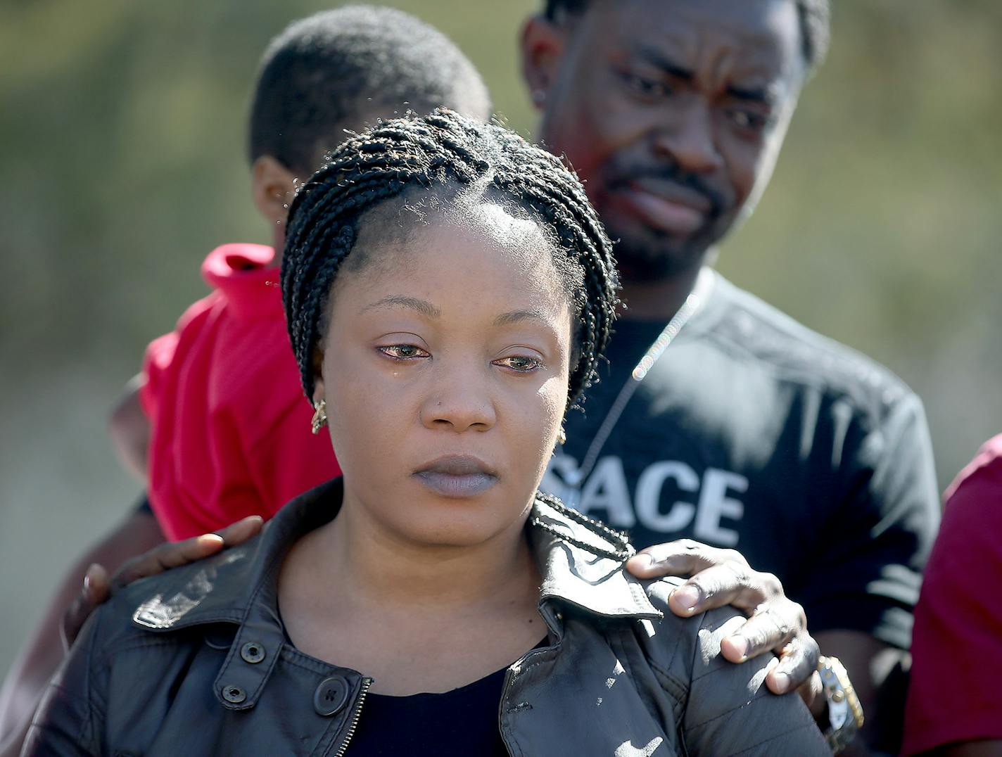 Yamah Collins is comforted by her family members as Pastor Harding Smith made a statement regarding formal charges against Pierre Collins, Tuesday, April 14, 2015 in Crystal, MN. ] (ELIZABETH FLORES/STAR TRIBUNE) ELIZABETH FLORES &#x2022; eflores@startribune.com