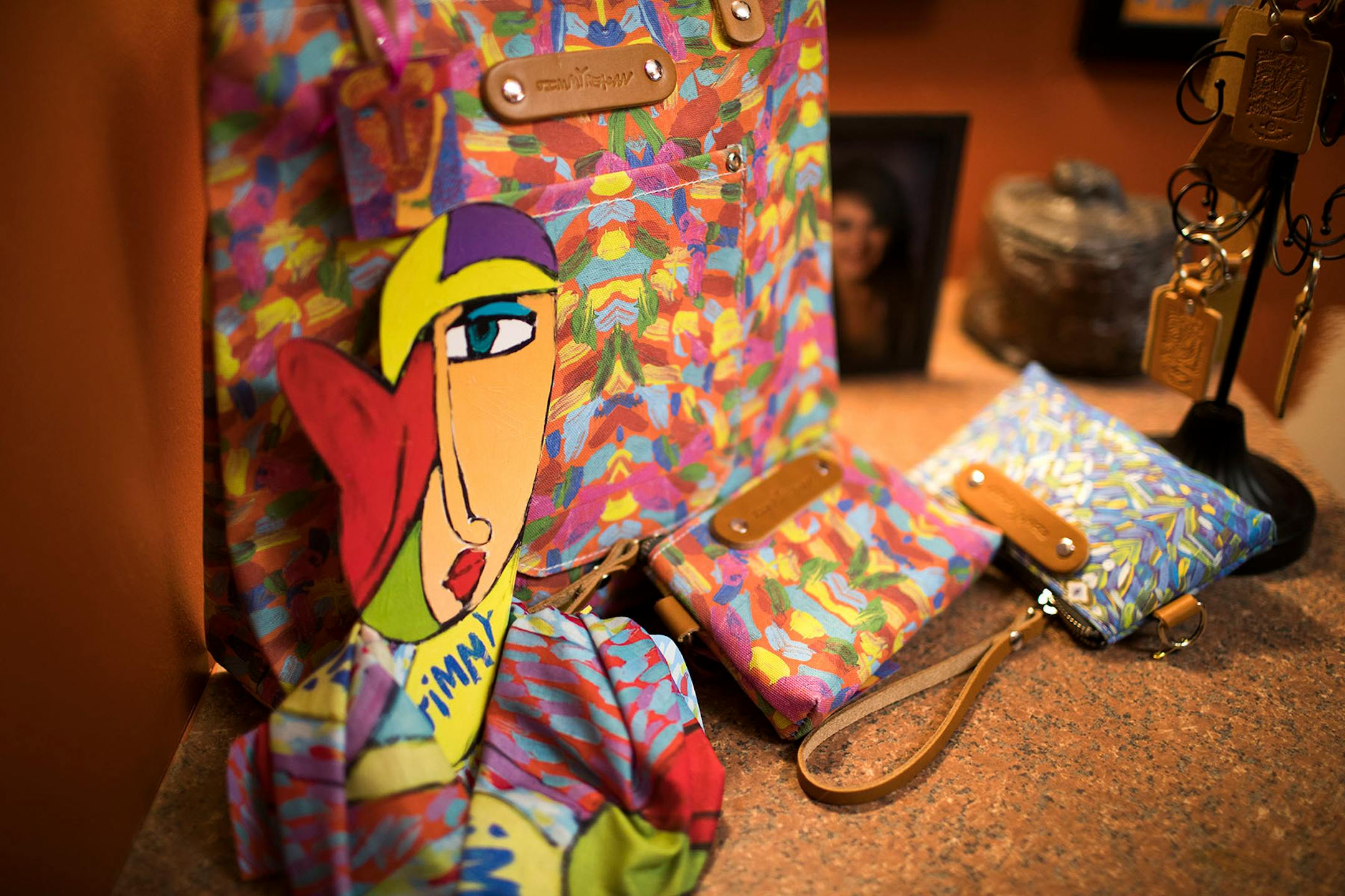 Bags, wallets and scarfs that were made from Jimmy Reagan's paintings.