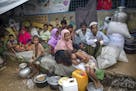 Rohingya Muslims, who crossed over from Myanmar into Bangladesh, rest inside a school compound at Kutupalong refugee camp, Bangladesh, Monday, Oct. 23