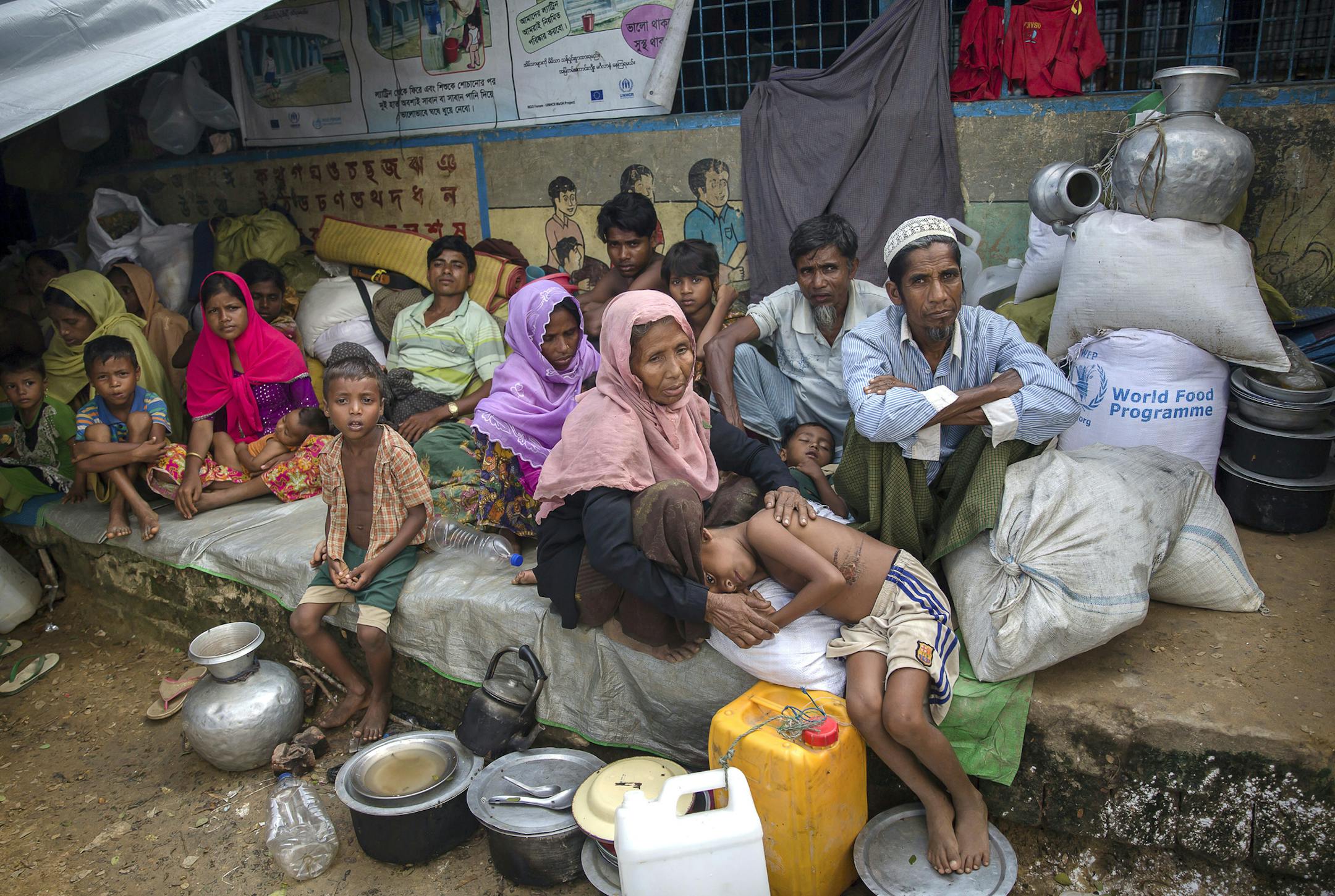 Rohingya Muslims, who crossed over from Myanmar into Bangladesh, rest inside a school compound at Kutupalong refugee camp, Bangladesh, Monday, Oct. 23, 2017. Nearly 600,000 Rohingya Muslims have fled Myanmar's Rakhine state and arrived in Bangladesh since Aug. 25 to avoid persecution that the United Nations has called ethnic cleansing. (AP Photo/Dar Yasin)