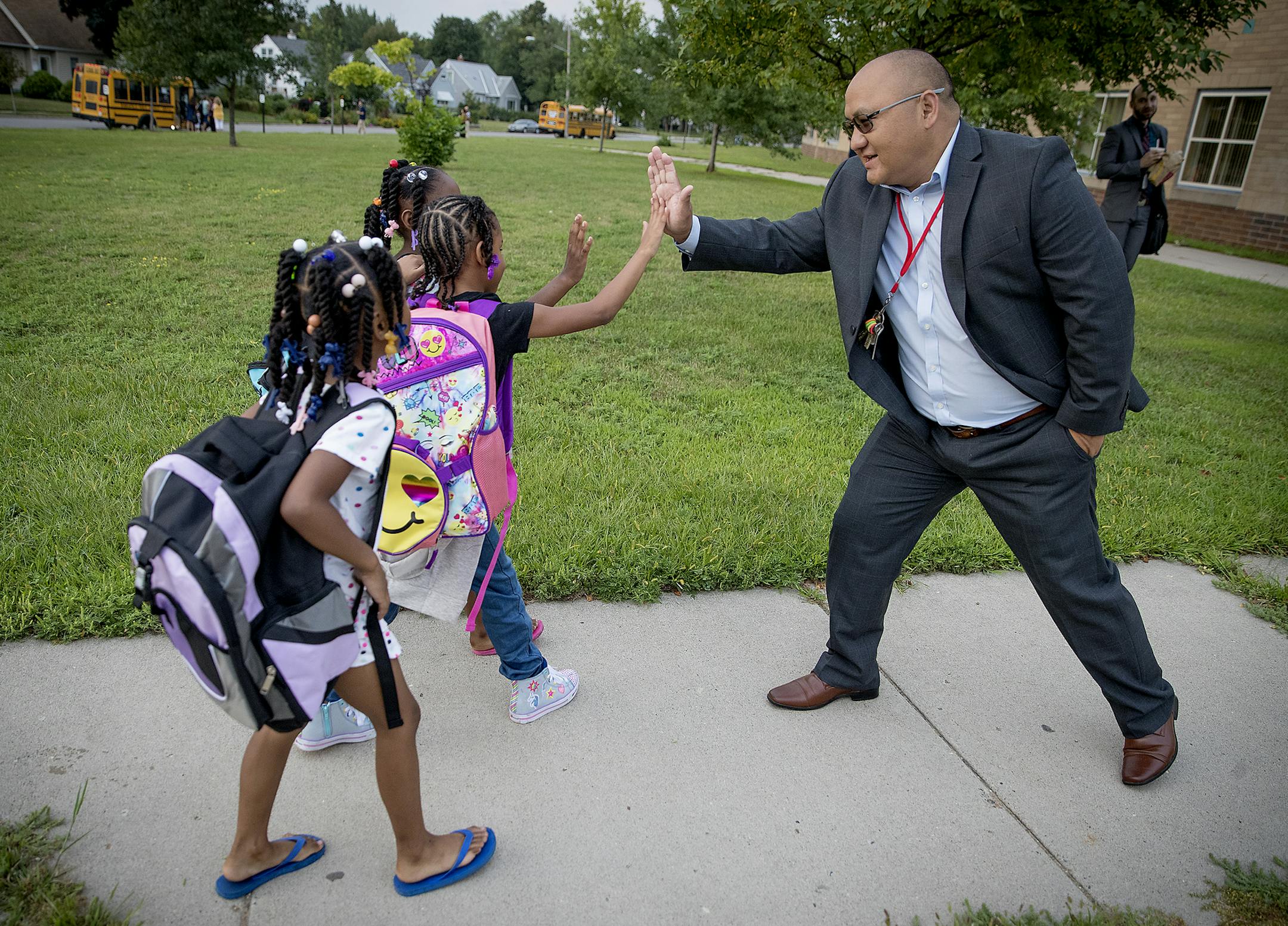 New Principal Pao Vue greeted students as they made their way into Jenny Lind Elementary School on the first day of school, Monday, August 27, 2018 in Minneapolis, MN. ] ELIZABETH FLORES ï liz.flores@startribune.com