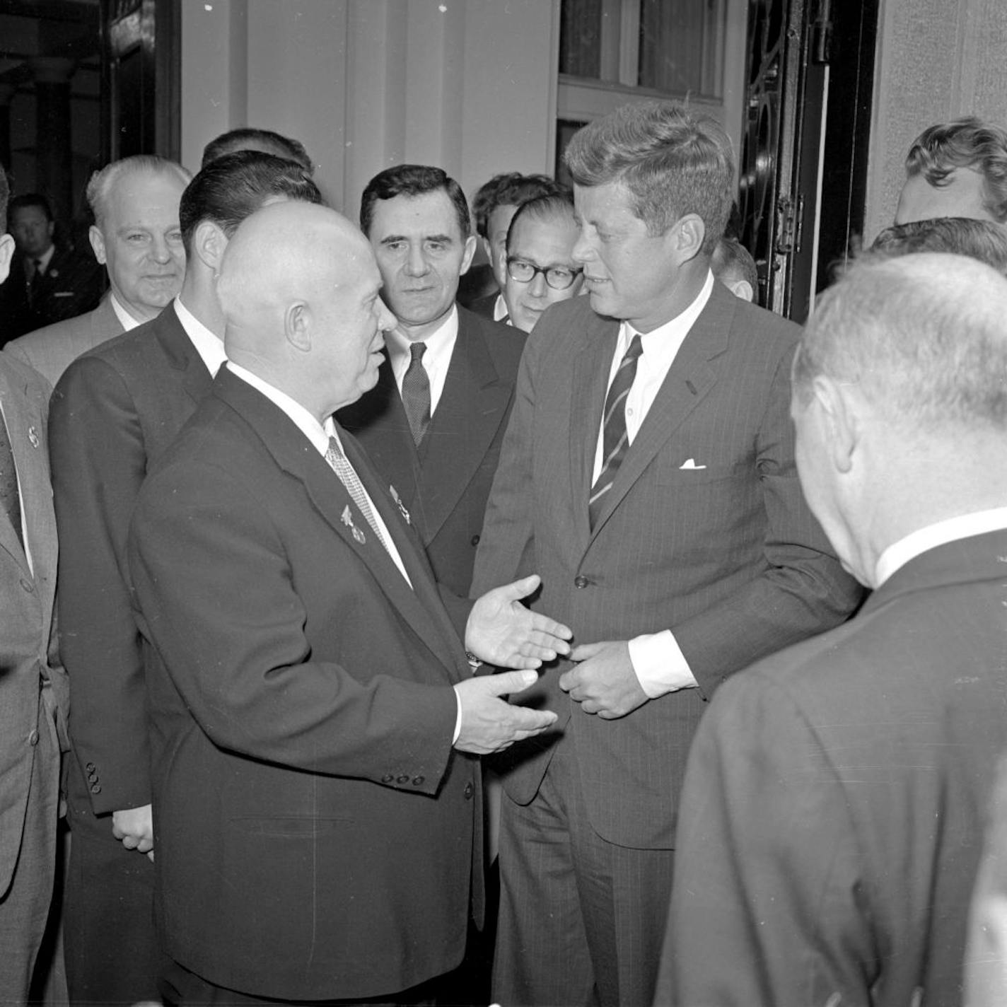 Soviet premier Nikita Khrushchev, left, and president John F. Kennedy address each other at the Soviet embassy in Vienna during their second day of talks, June 4, 1961. At center, background, is Andrei Gromyko, Soviet foreign minister.