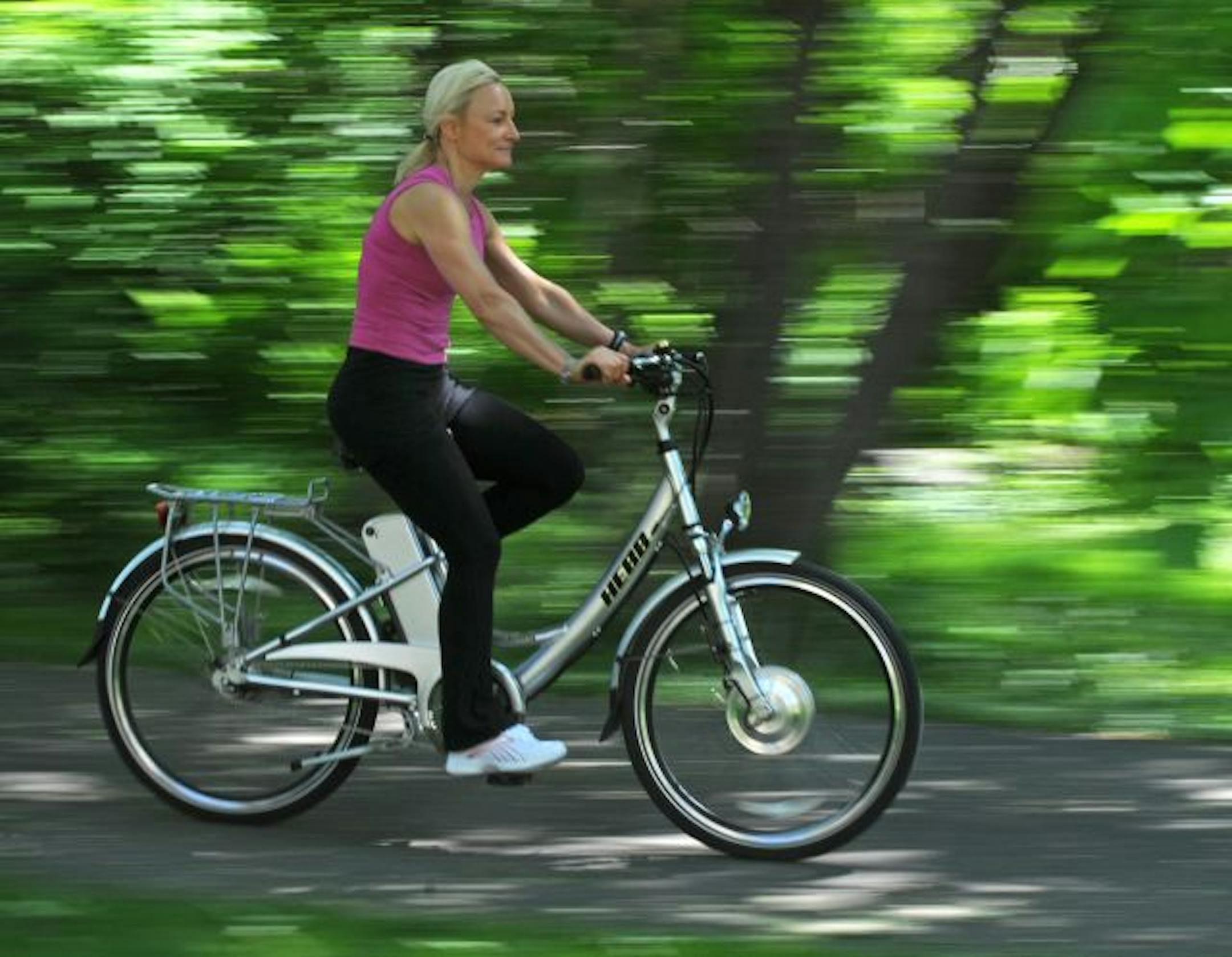 Karen Howells, 52, of Long Lake, says "most people don't even realize that it's an electric bike until I come right up on them." The bike can go 20 miles per hour; a charged battery powers it for 10 to 25 miles without pedaling.