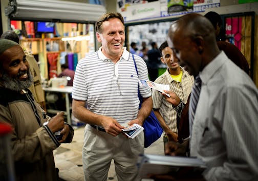 State Rep. Jim Abeler asked Somalis for their vote in the August 12 primary in his race against Mike McFadden to go up against Sen. Al Franken for the U.S. Senate seat. He handed out brochures in both English and Somali Friday after prayers at Somali Village Market in Minneapolis. ] Friday, August 1, 2014. GLEN STUBBE * gstubbe@startribune.com ORG XMIT: MIN1408011641271205