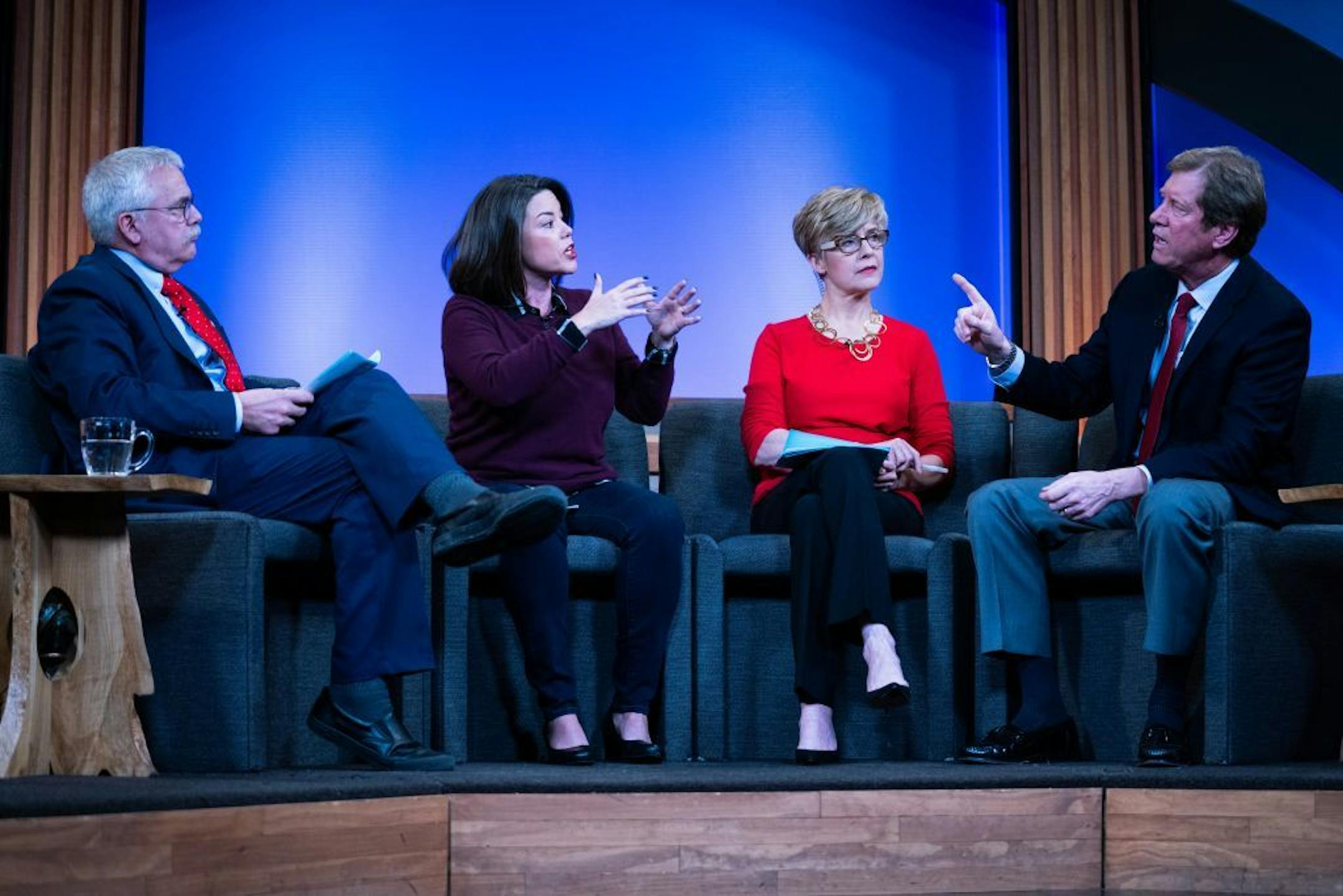 Rep. Jason Lewis and Democratic challenger Angie Craig debate on "Almanac." Eric Eskola, left, and Cathy Wurzer, in red, hosted the debate.
