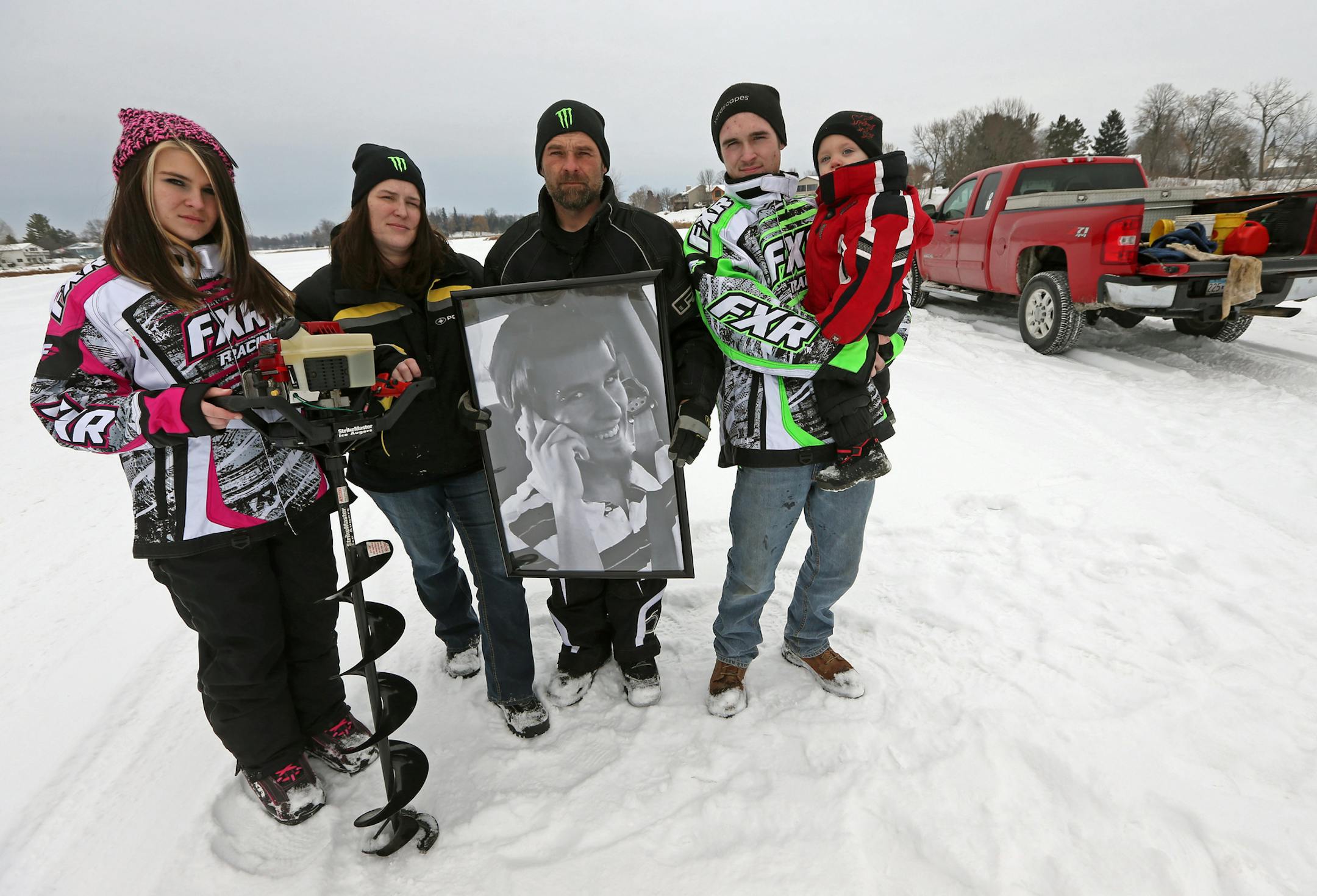 (left to right) Katelyn Steuernagle, Deanna Steuernagle, Jeff Steuernagle (holding photo of Jacob Steuernagle), Joshua Steuernagle and Kaden Steuernagle (son of Joshua) were photographed on North Center Lake in Lindstrom on 12/21/13. The family is holding a small ice fishing contest on the lake, to raise money in memory of their deceased son Jacob.] Bruce Bisping/Star Tribune bbisping@startribune.com Deanna Steuernagle, Jeff Steuernagle, Jacob Steuernagle, Joshua Steuernagle, Kaden Steuernagle,