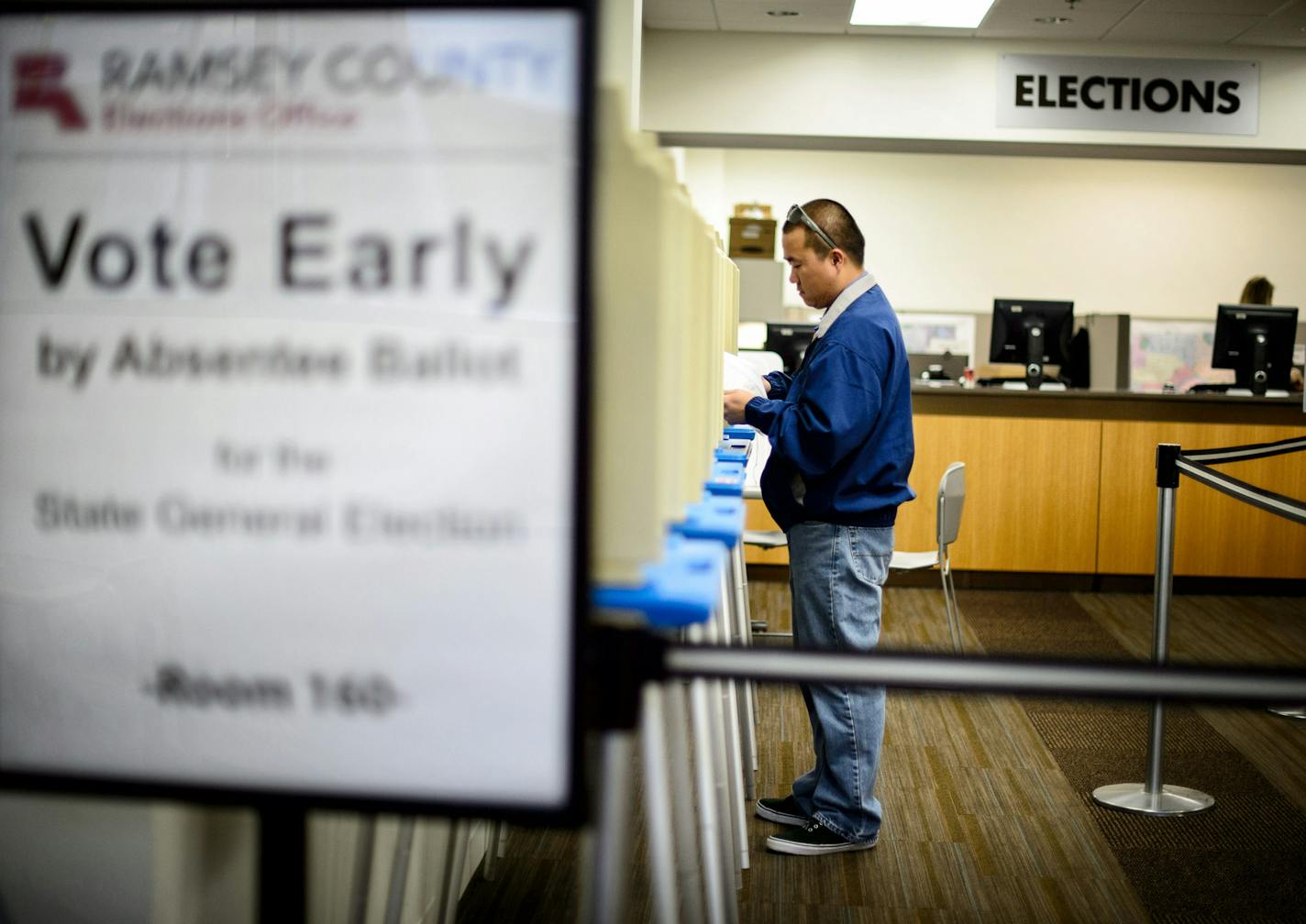 Ko Vang of St. Paul filled out his ballot. ] GLEN STUBBE * gstubbe@startribune.com Processing absentee ballots at the Ramsey County elections office Monday October 20, 2014