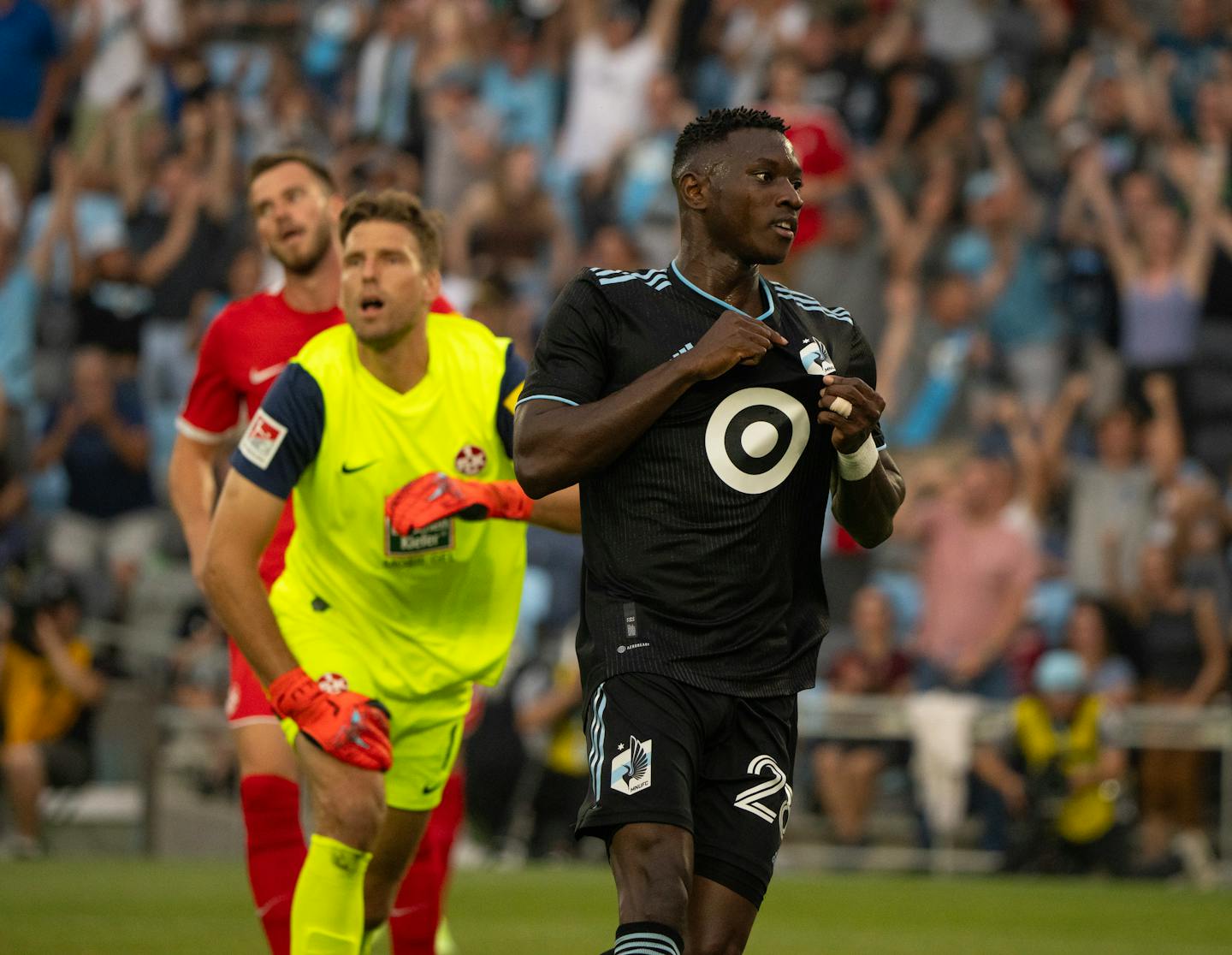 Minnesota United forward Mender García (28) pointed to the team logo on his jersey after he scored on FC Kaiserslautern goalkeeper Andreas Luthe, rear, to tie the game 1-1 in the first half Wednesday night. The Minnesota United FC faced the FC Kaiserslautern in an international friendly Wednesday night, June 28, 2023 at Allianz Field in St. Paul. ] JEFF WHEELER • jeff.wheeler@startribune.com