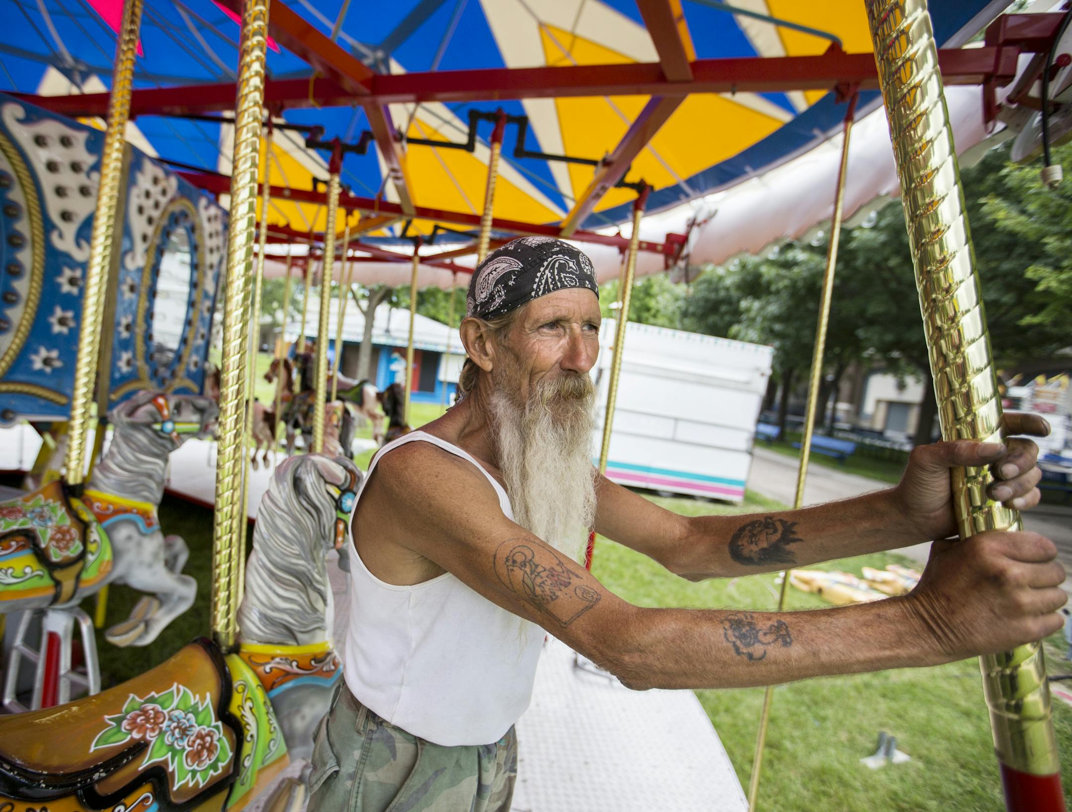 Craig "Mr. Crabs" Moore takes a break while setting up the carousel near the Grandstands at the Minnesota State Fairgrounds. Moore has been working for the St. Louis-based company that sets up rides since 1973. "It's been a strange life," said Moore. ] (Leila Navidi/Star Tribune) leila.navidi@startribune.com BACKGROUND INFORMATION: Rides and booths set up the week before the Minnesota State Fair in Falcon Heights on Thursday, August 18, 2016.