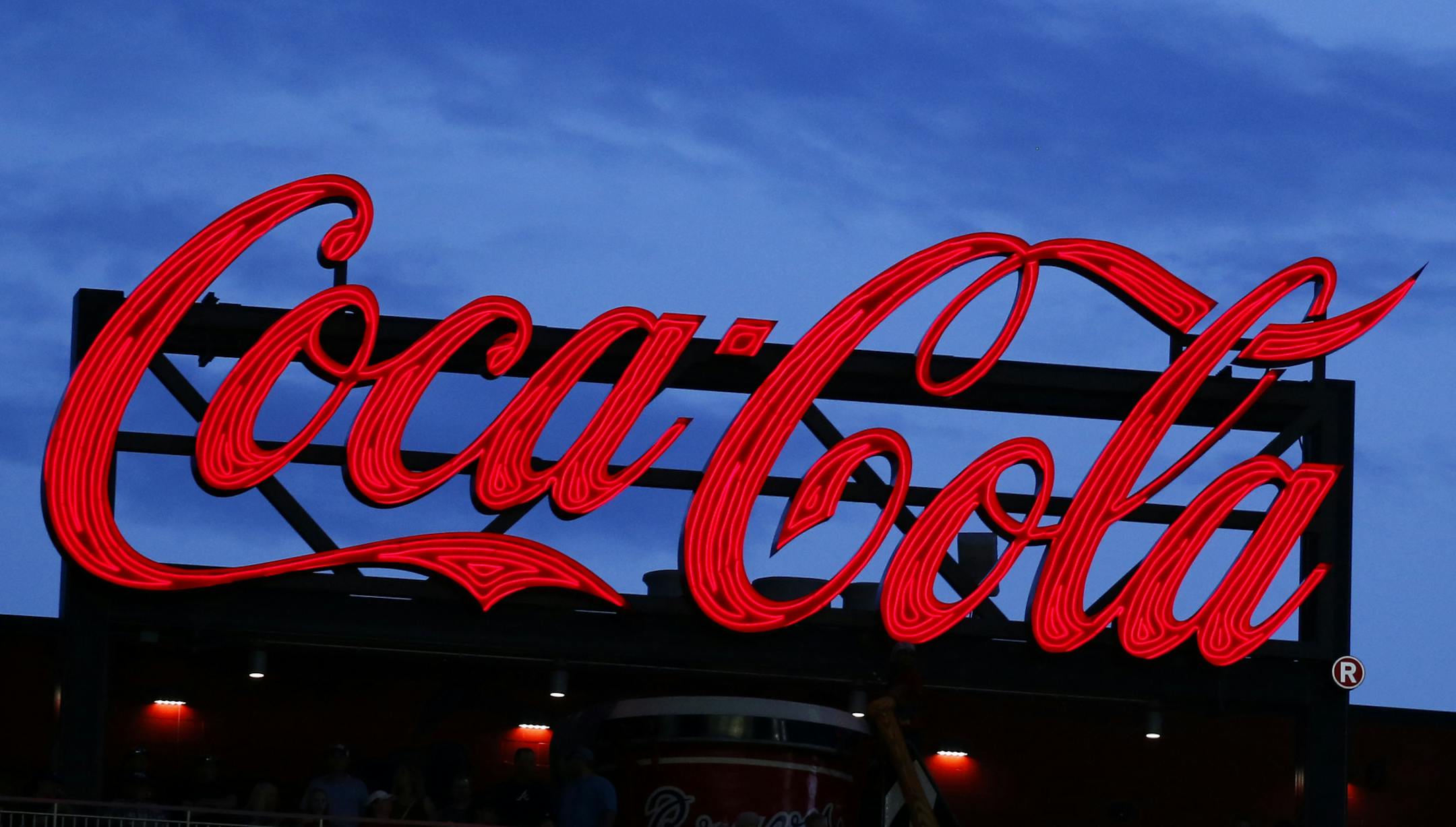 FILE - In this July 20, 2019, photo a Coca-Cola billboard is shown over left field at SunTrust Park during a baseball game between the Washington Nationals and Atlanta Braves in Atlanta. Coca-Cola hits its low point in the second quarter of 2020, with revenue plunging 28%, but says sales are improving as lockdowns ease globally. (AP Photo/John Bazemore, File)