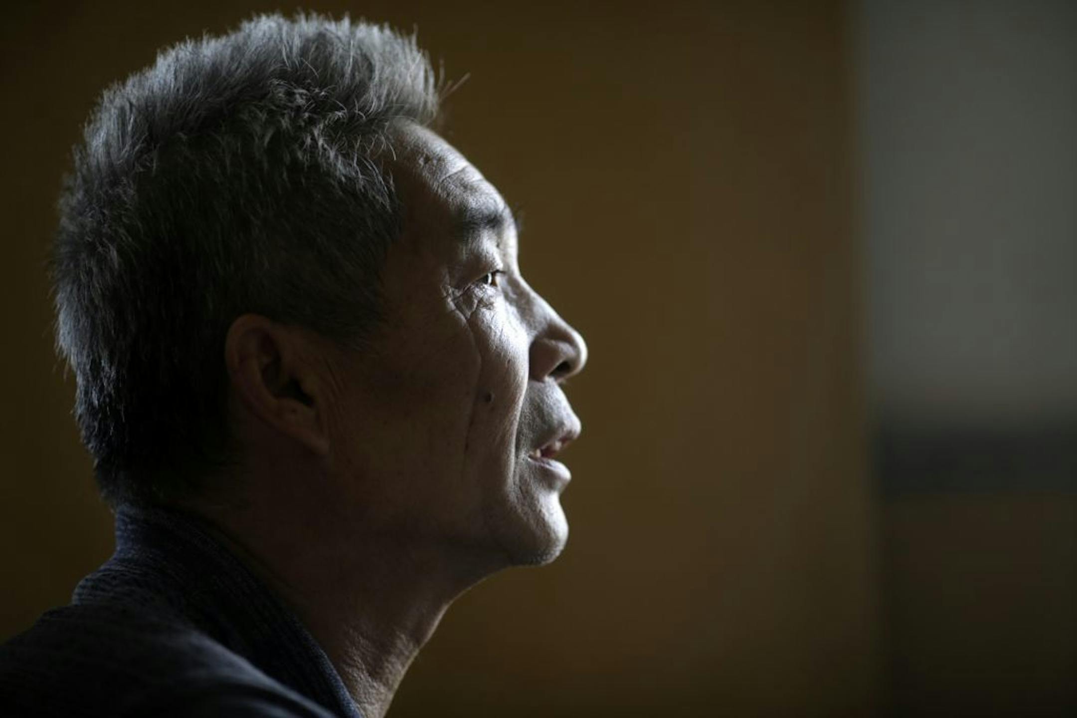 In this Sept. 9, 2013 photo, Dong Linhua, 59, speaks at his home in Shanghai.