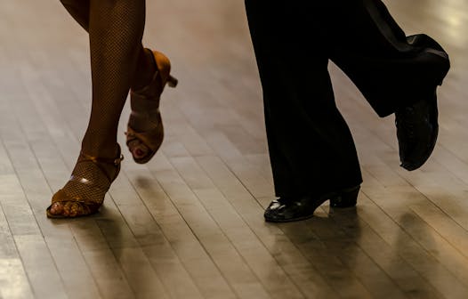 Dancing starts with the feet. These feet belong to Janell Pepper, a retired corporate attorney, and instructor Dustin Donelan. They demonstrated their routines at Cinema Ballroom’s annual Dance Ex event, a mock contest in which professional judges provide individual critiques.