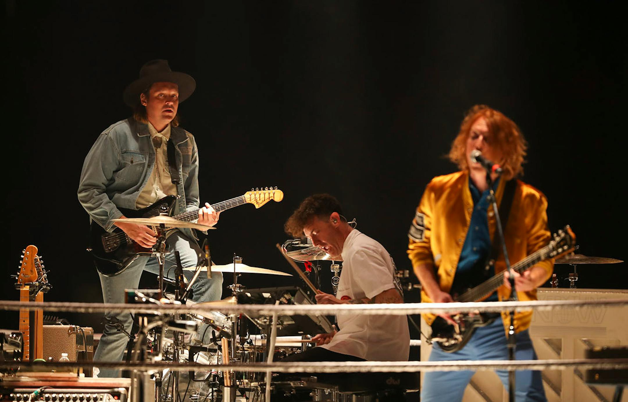 Win Butler, Jeremy Gara, and Richard Reed Parry, from left, of Arcade Fire during their show at Xcel Energy Center in St. Paul Sunday night.