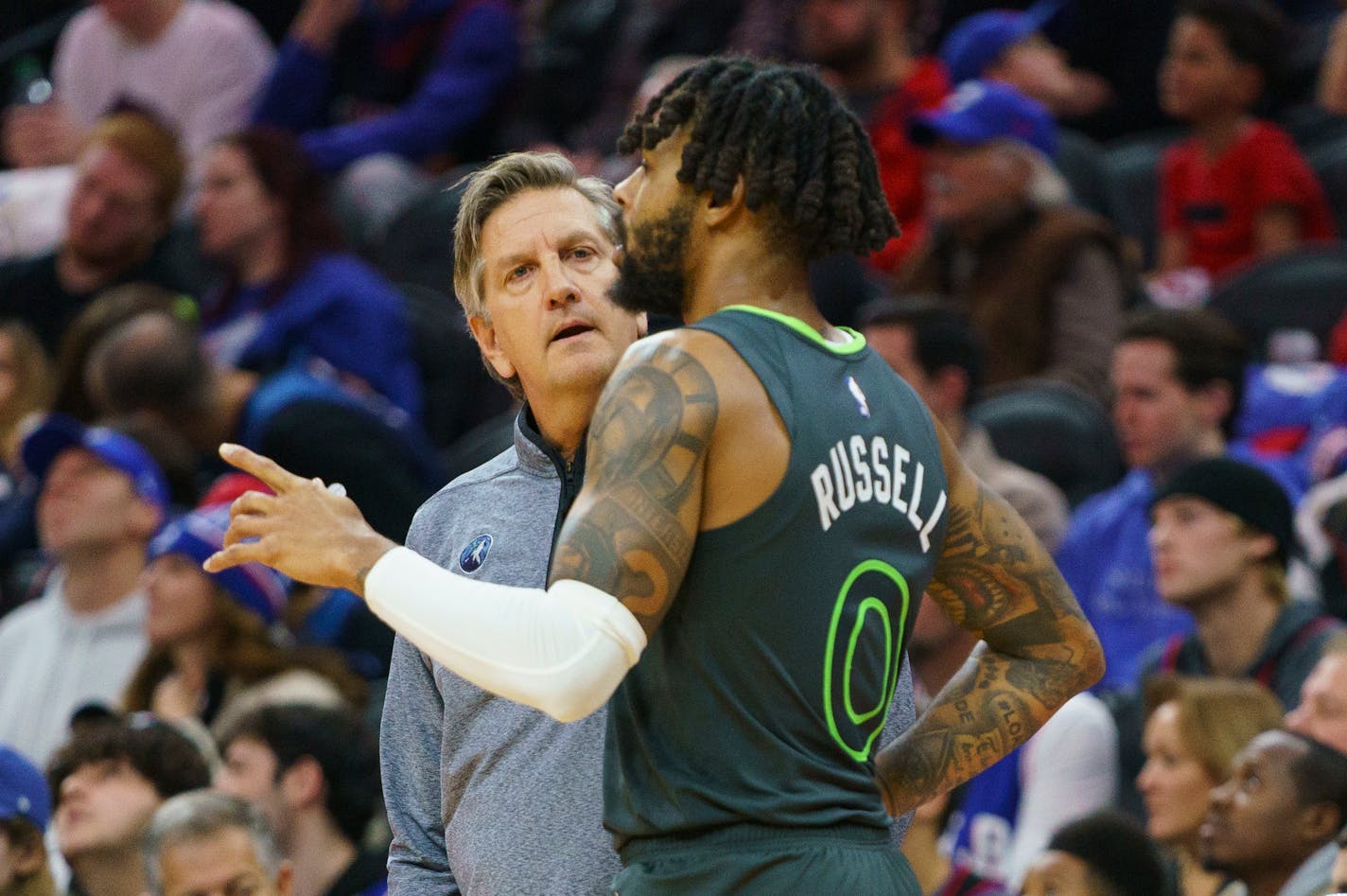 Timberwolves coach Chris Finch listens to D'Angelo Russell during Saturday night's win at Philadelphia