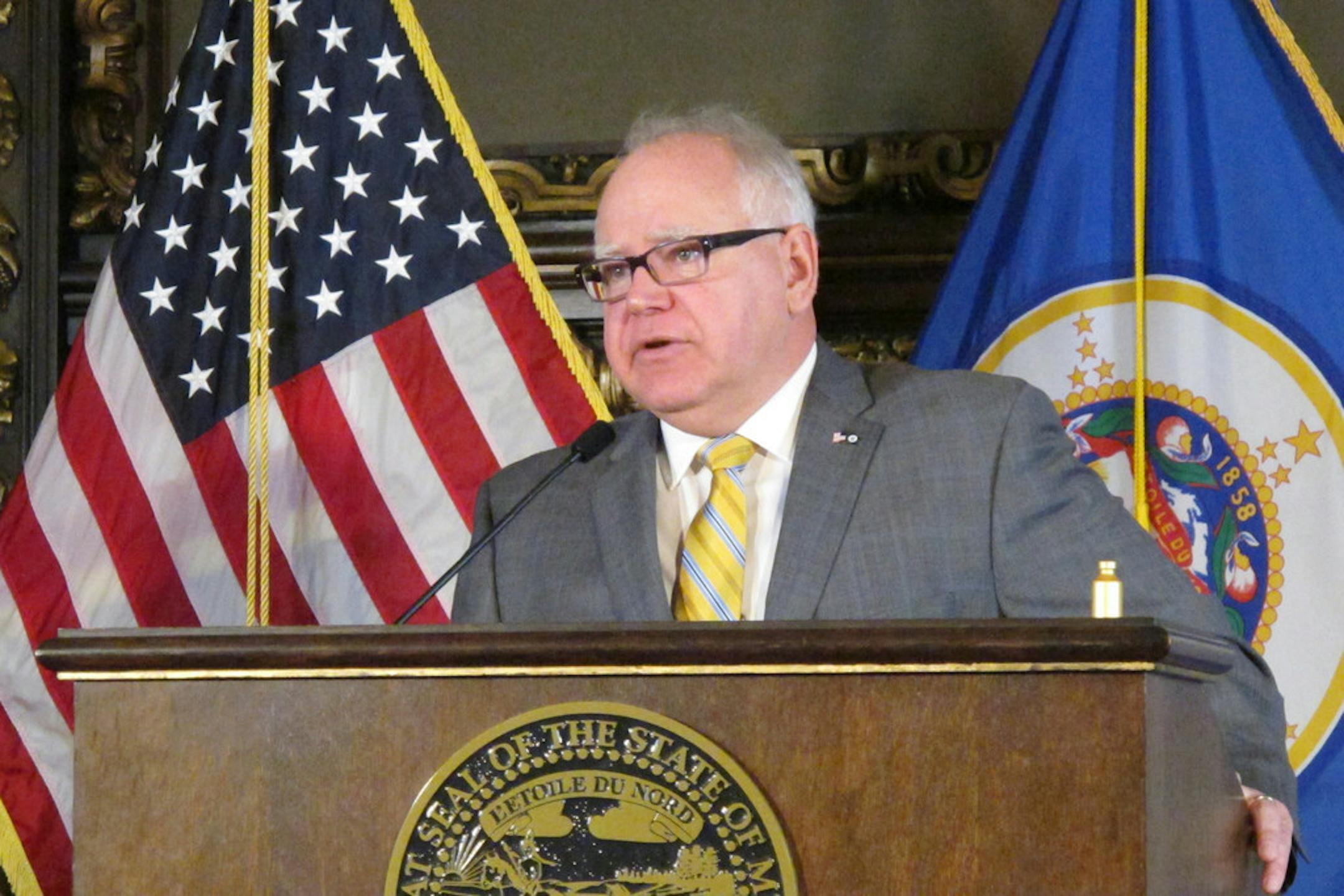 Minnesota Gov. Tim Walz called Monday for public hearings as a way to break an impasse over insulin affordability legislation. At right is an empty insulin vial painted gold.