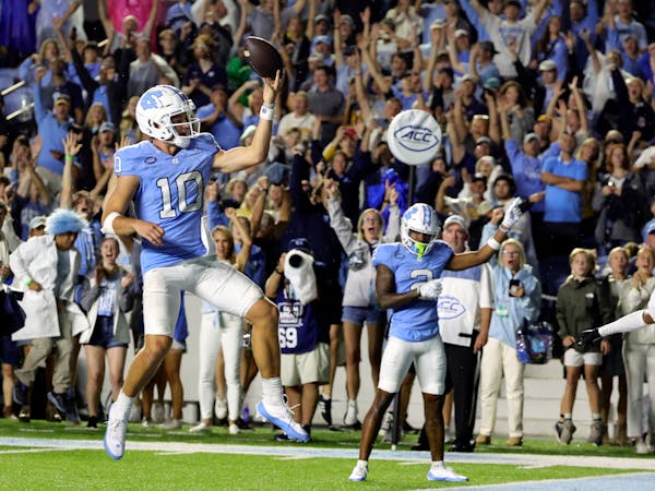 North Carolina quarterback Drake Maye celebrated a rushing touchdown in double overtime against Appalachian State on Saturday in Chapel Hill, N.C.
