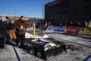 Adam Zemlicka piloted Frostbyte, a robotic snowplow machine developed by students at Lake Area Technical College, as it competed in the Autonomous Sno